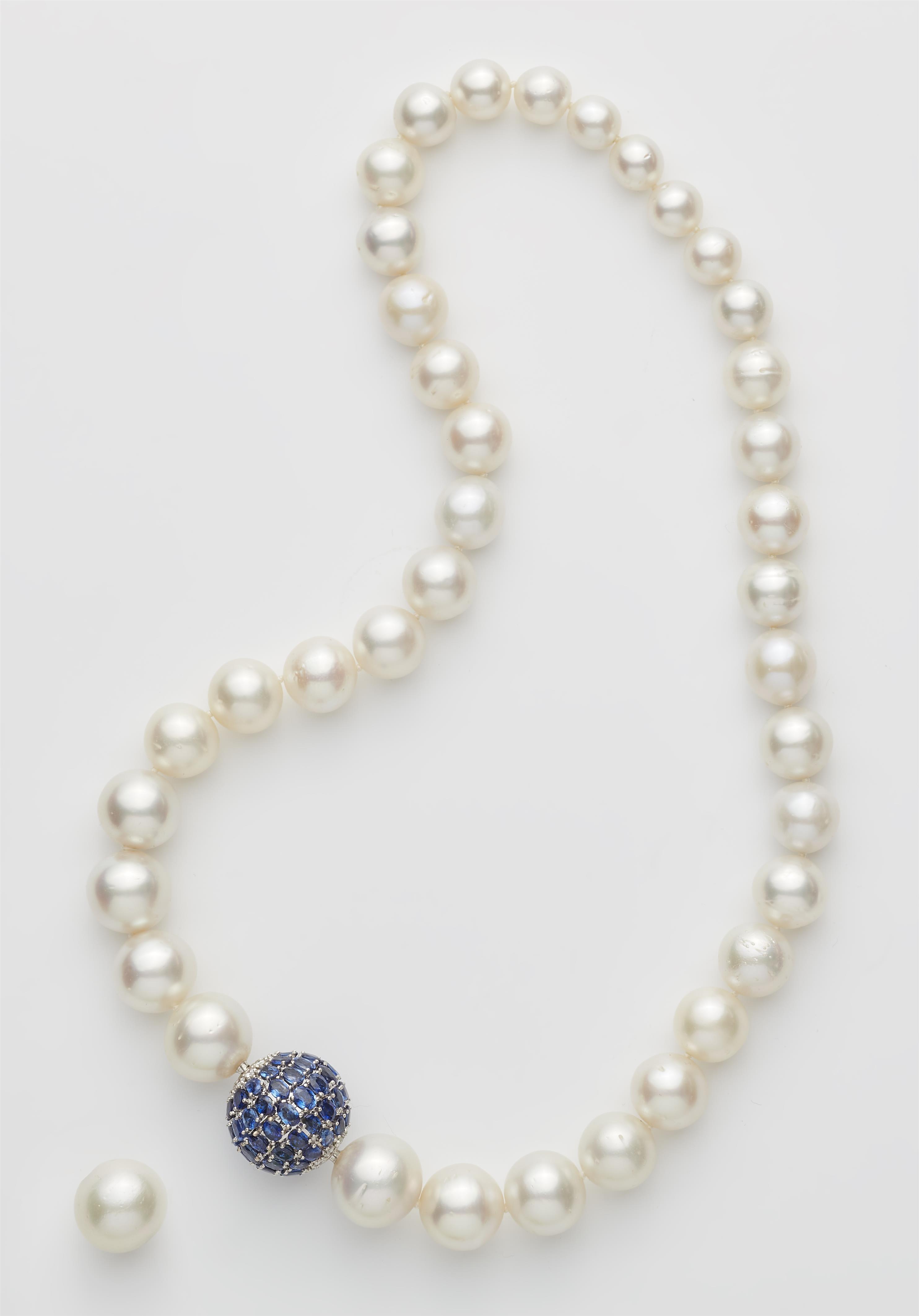 A South Sea pearl necklace with interchangeable 18k white gold sapphire and diamond ball clasp with bayonet fastening. - image-1