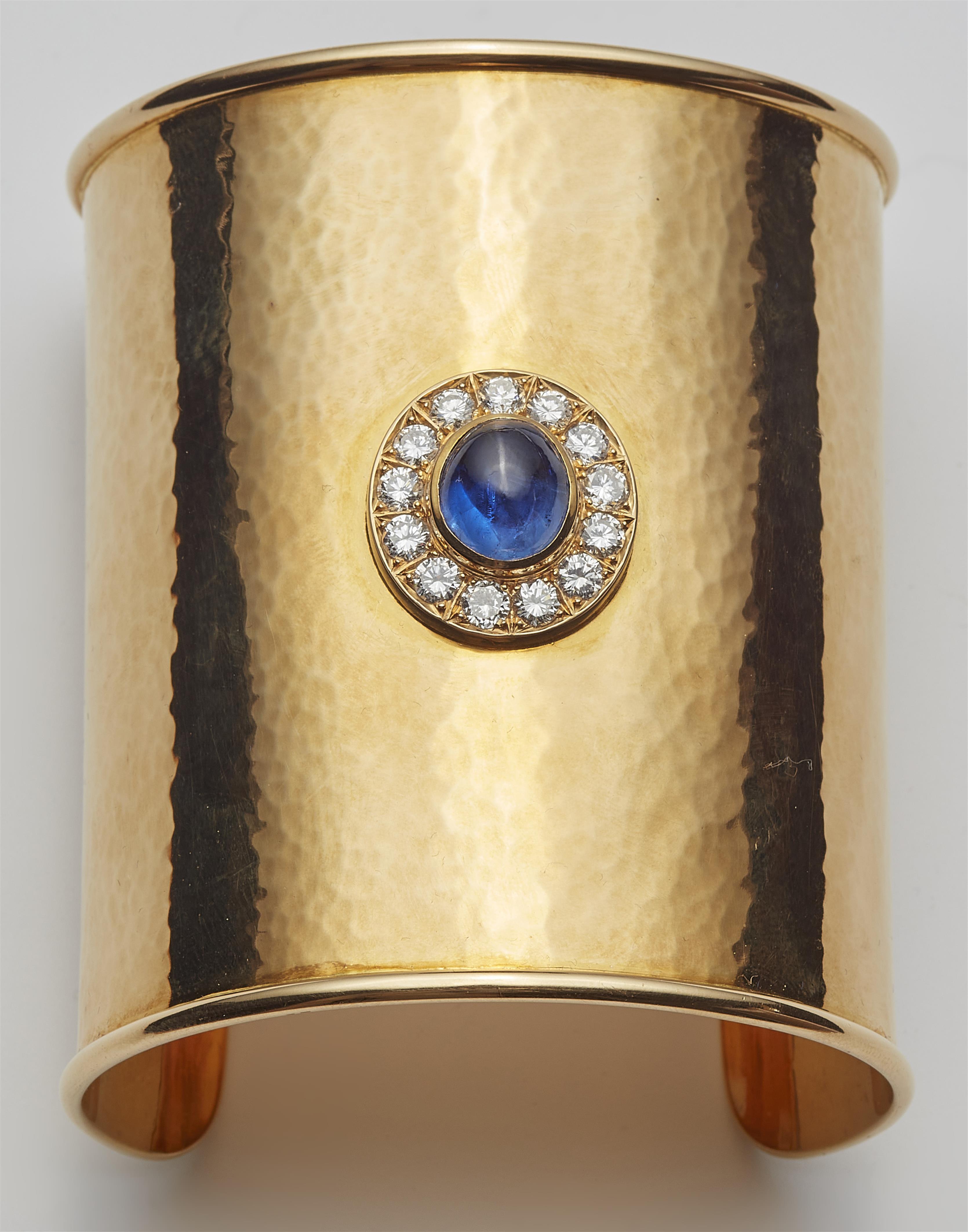 A custom made 18k yellow gold diamond and Ceylon sapphire cabochon cuff bracelet. - image-2