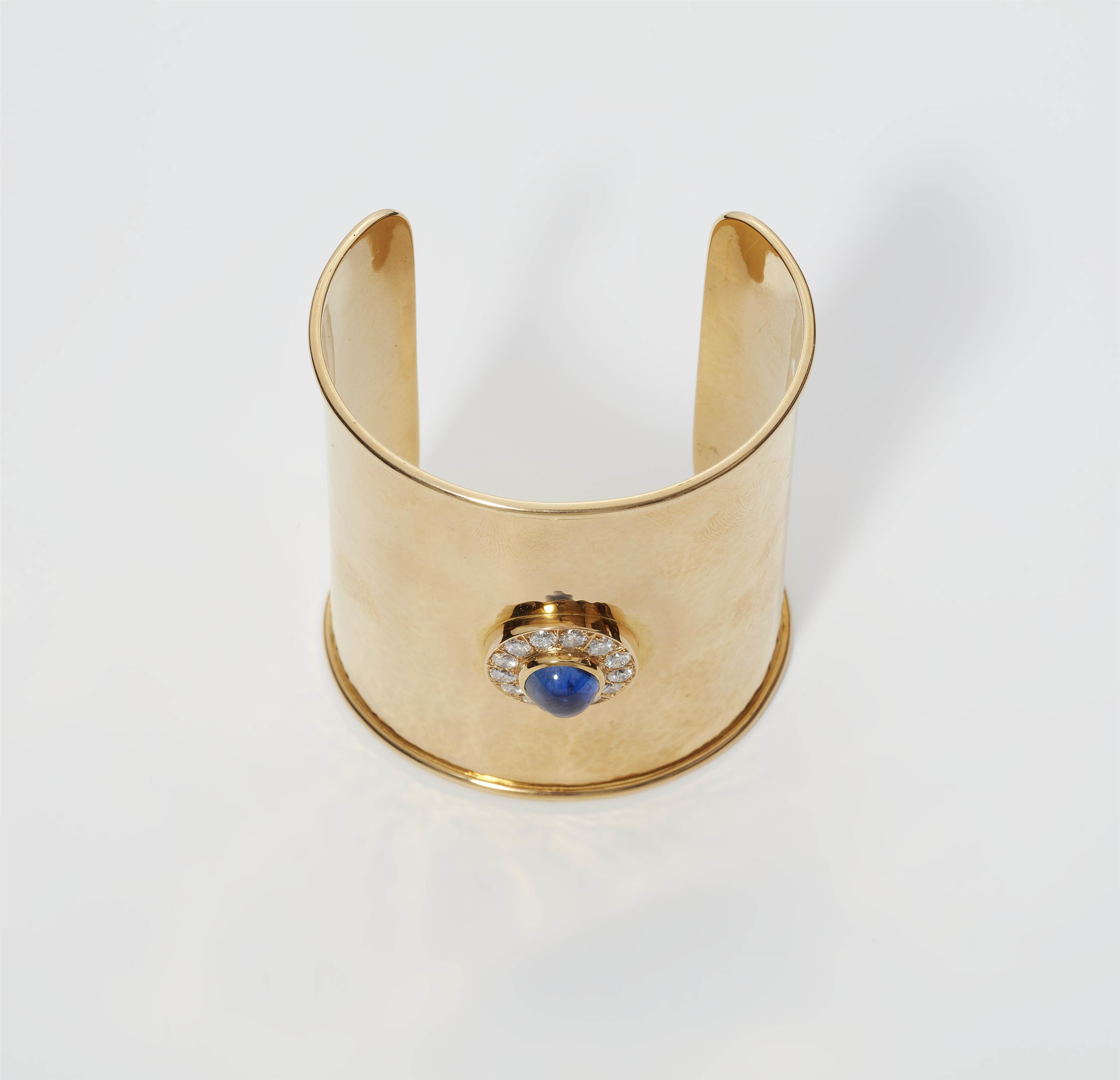 A custom made 18k yellow gold diamond and Ceylon sapphire cabochon cuff bracelet. - image-1