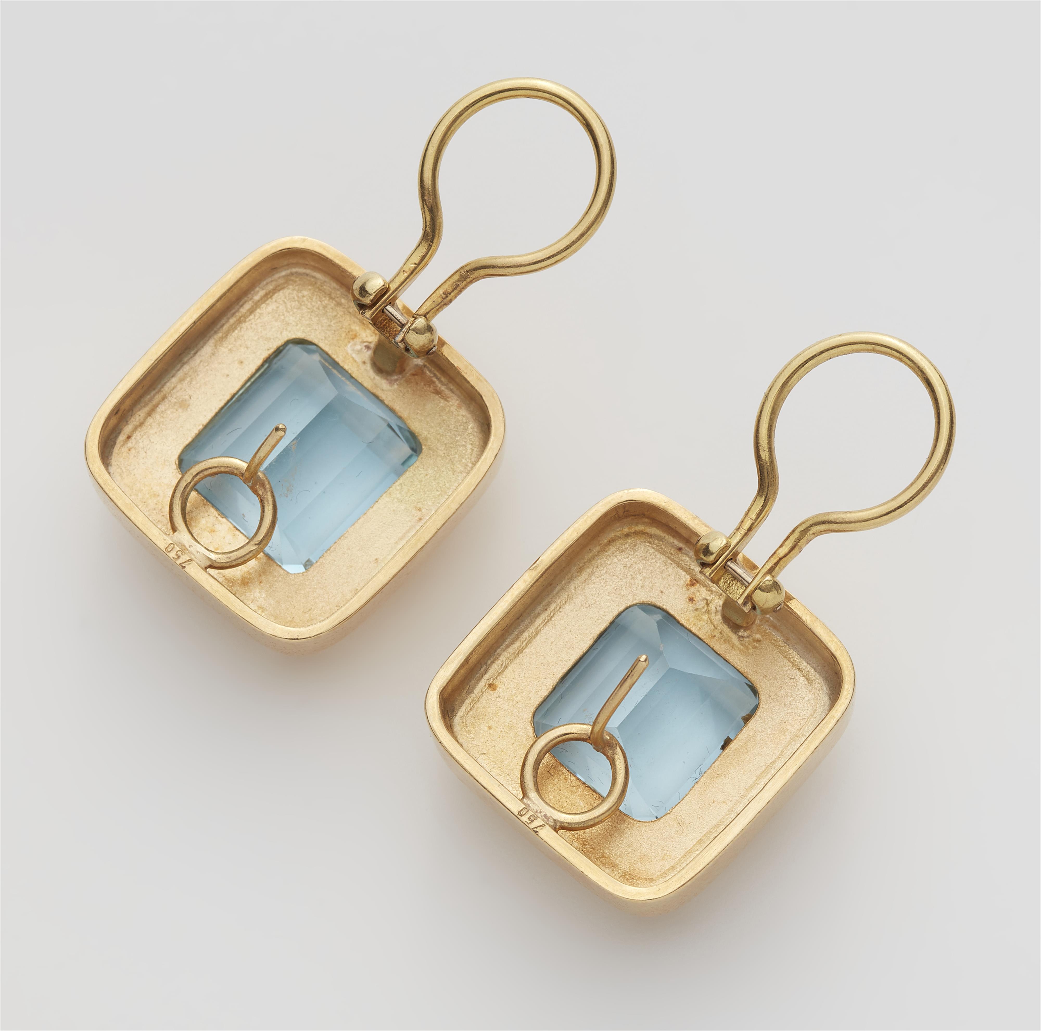 A pair of 18k gold and step-cut aquamarine clip earrings. - image-2