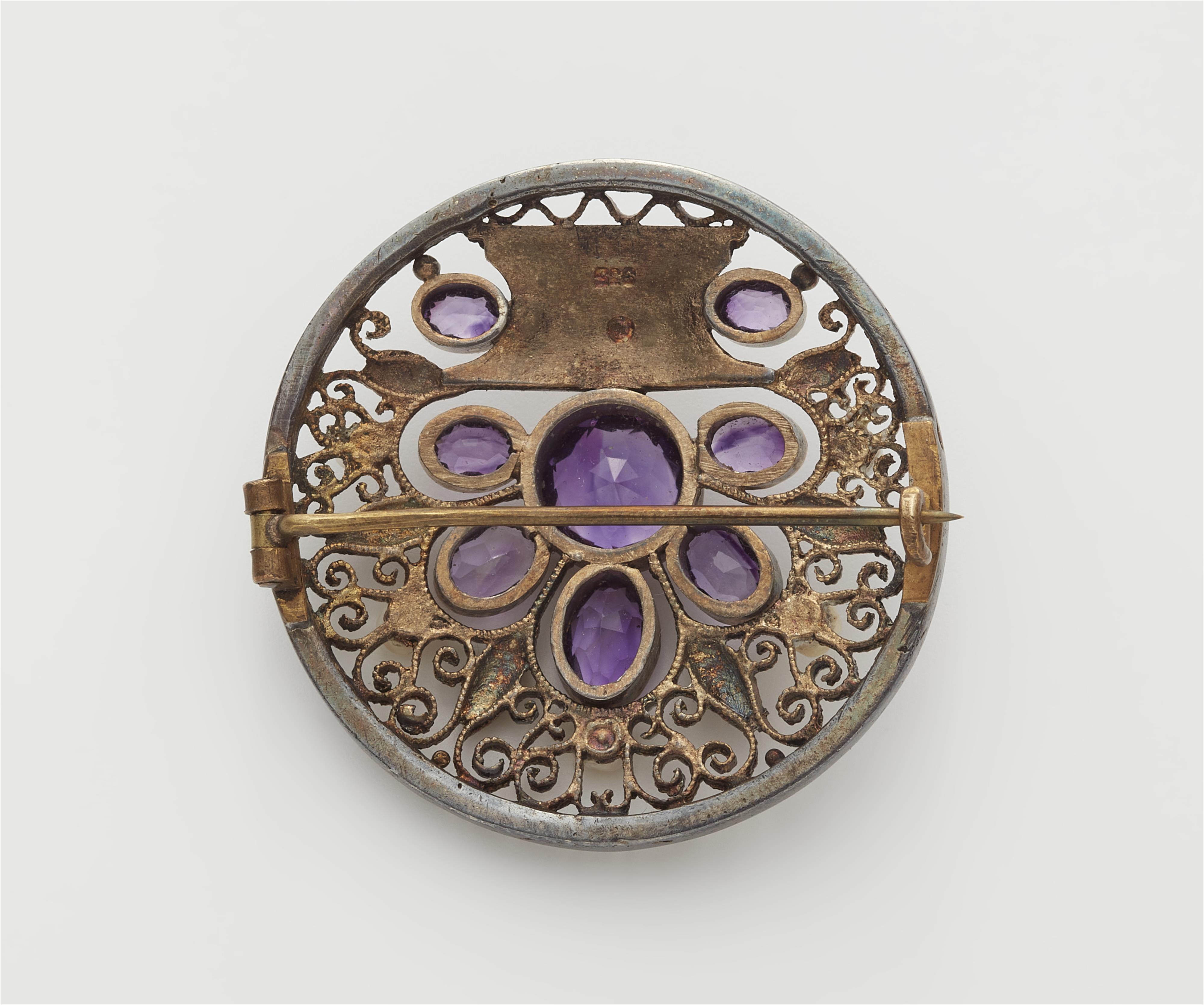 A gilded silver enamel pearl and amethyst disc brooch. - image-2