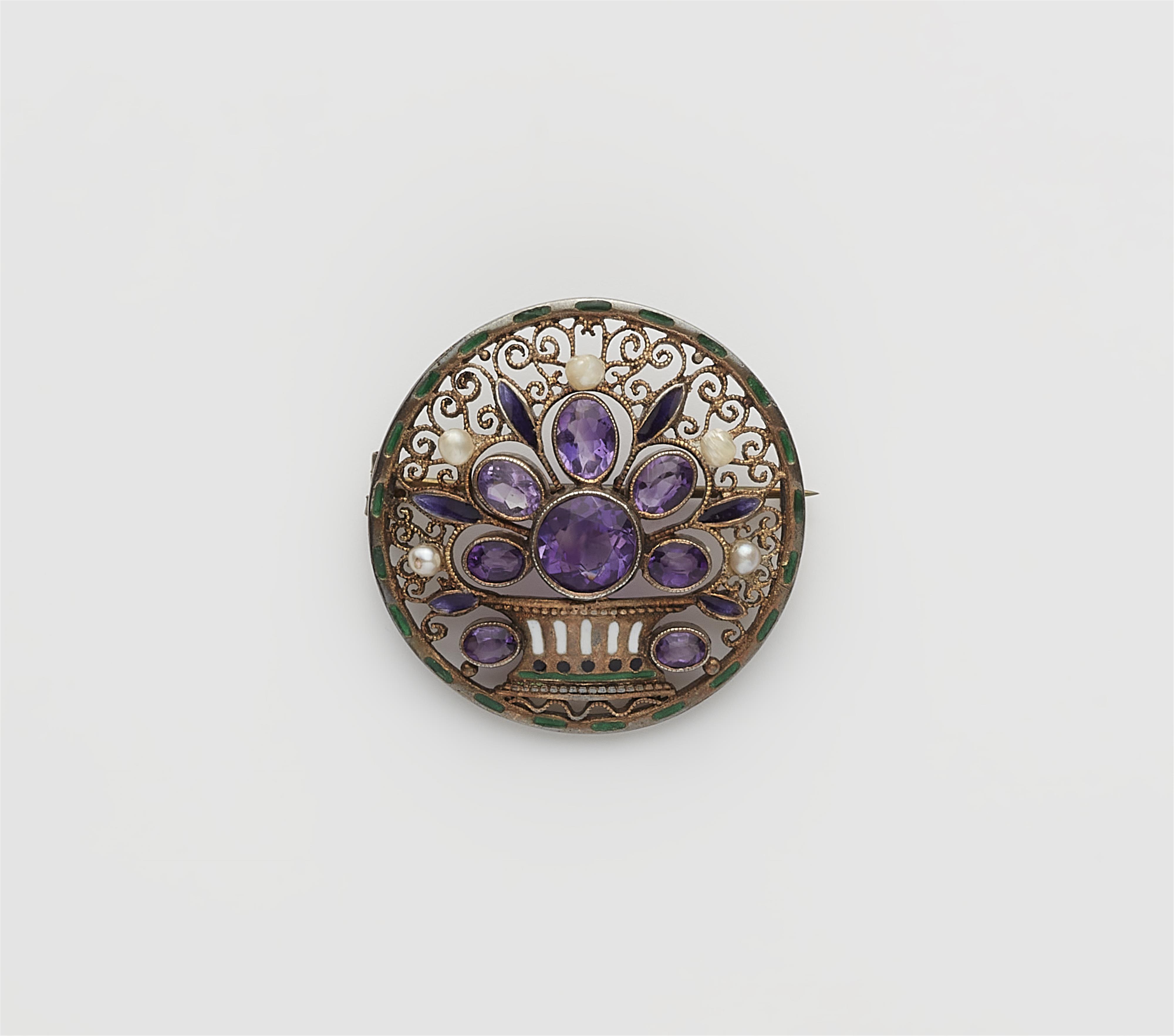 A gilded silver enamel pearl and amethyst disc brooch. - image-1