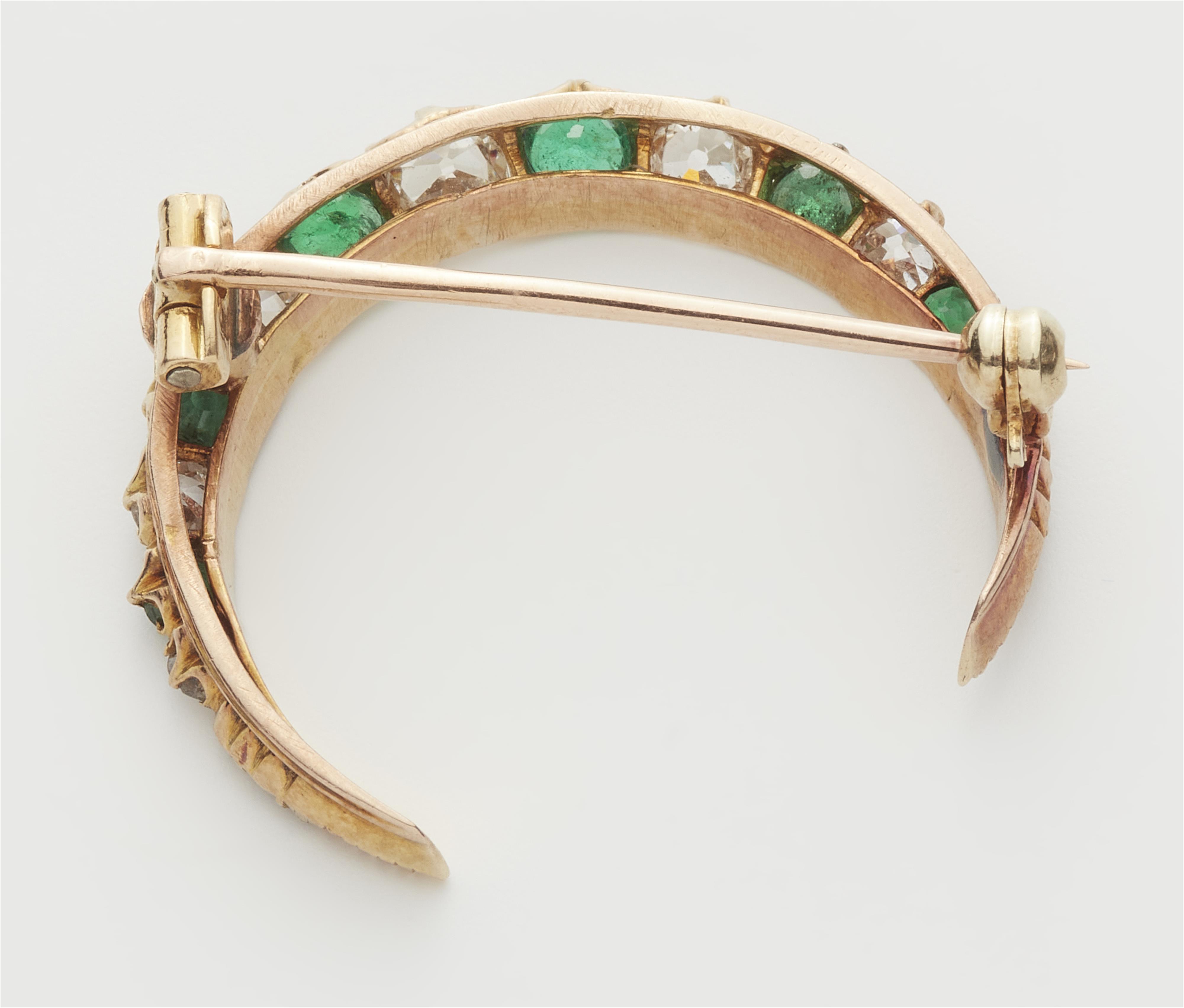 A 14k gold diamond and emerald crescent moon brooch. - image-2