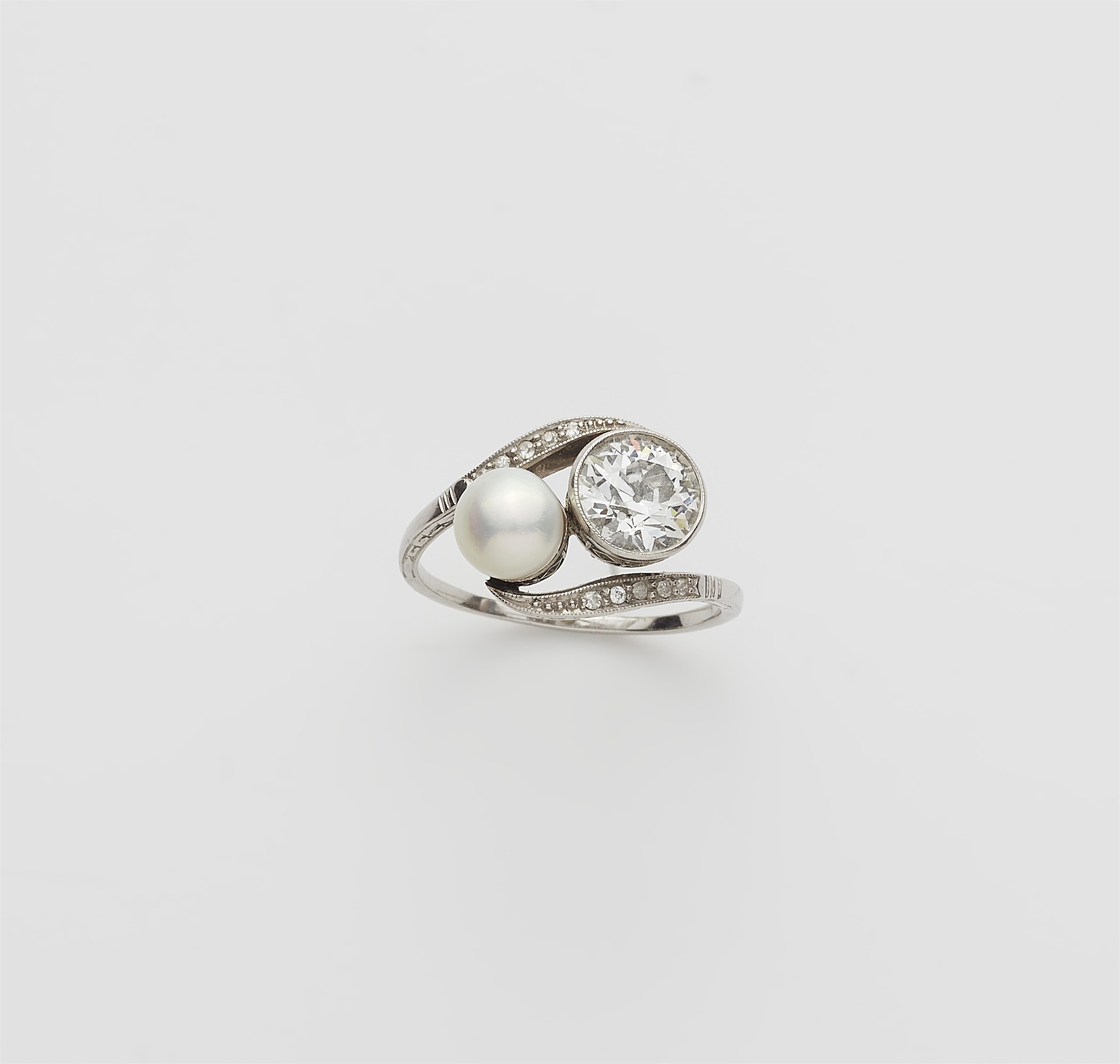 A platinum diamond toi et moi ring with a ca. 1.56 ct old-cut diamond solitaire and a bouton pearl. - image-1