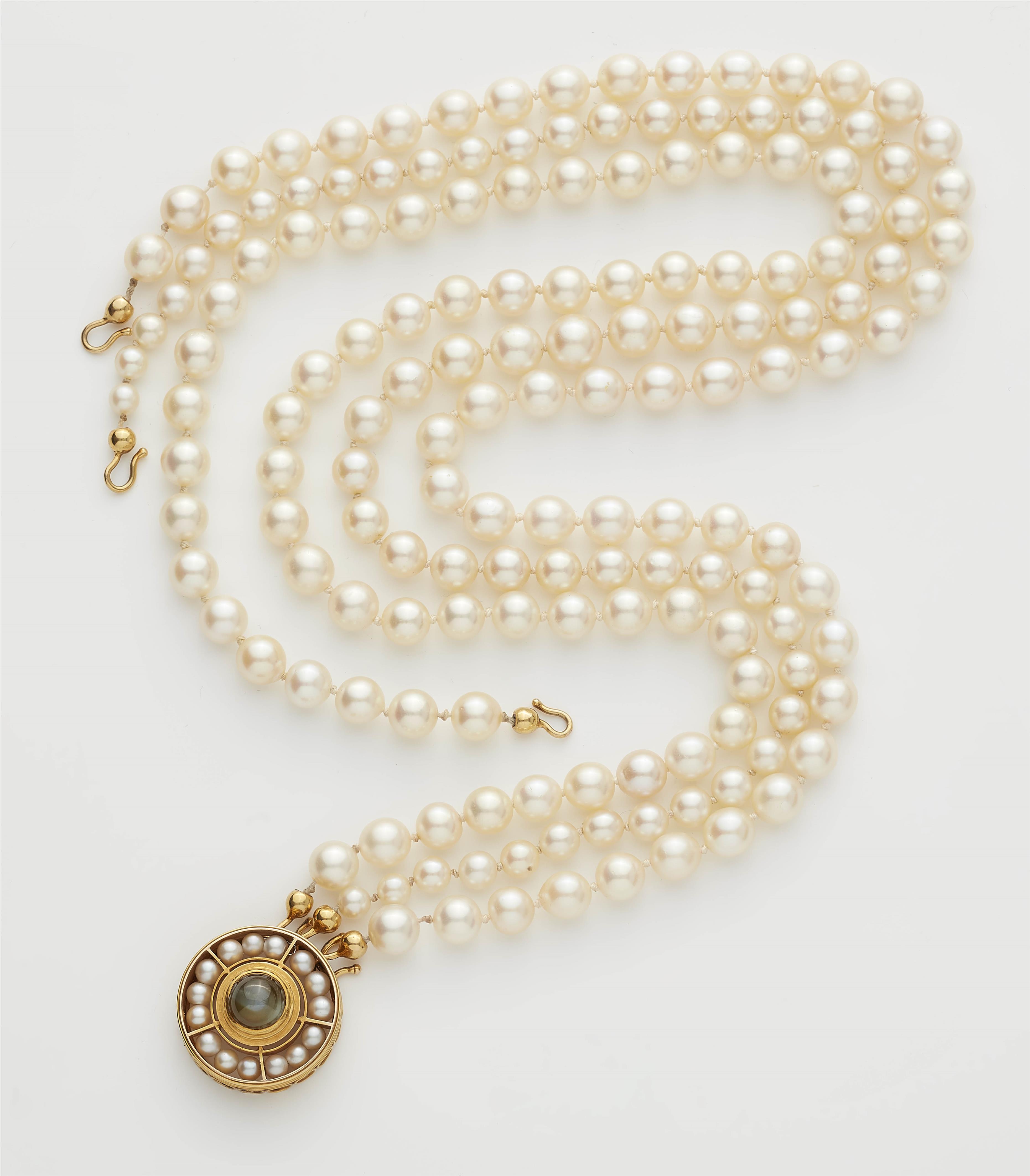 A German three stranded cultured pearl necklace with a circular 18k gold pearl and chrysoberyl cabochon clasp. - image-1