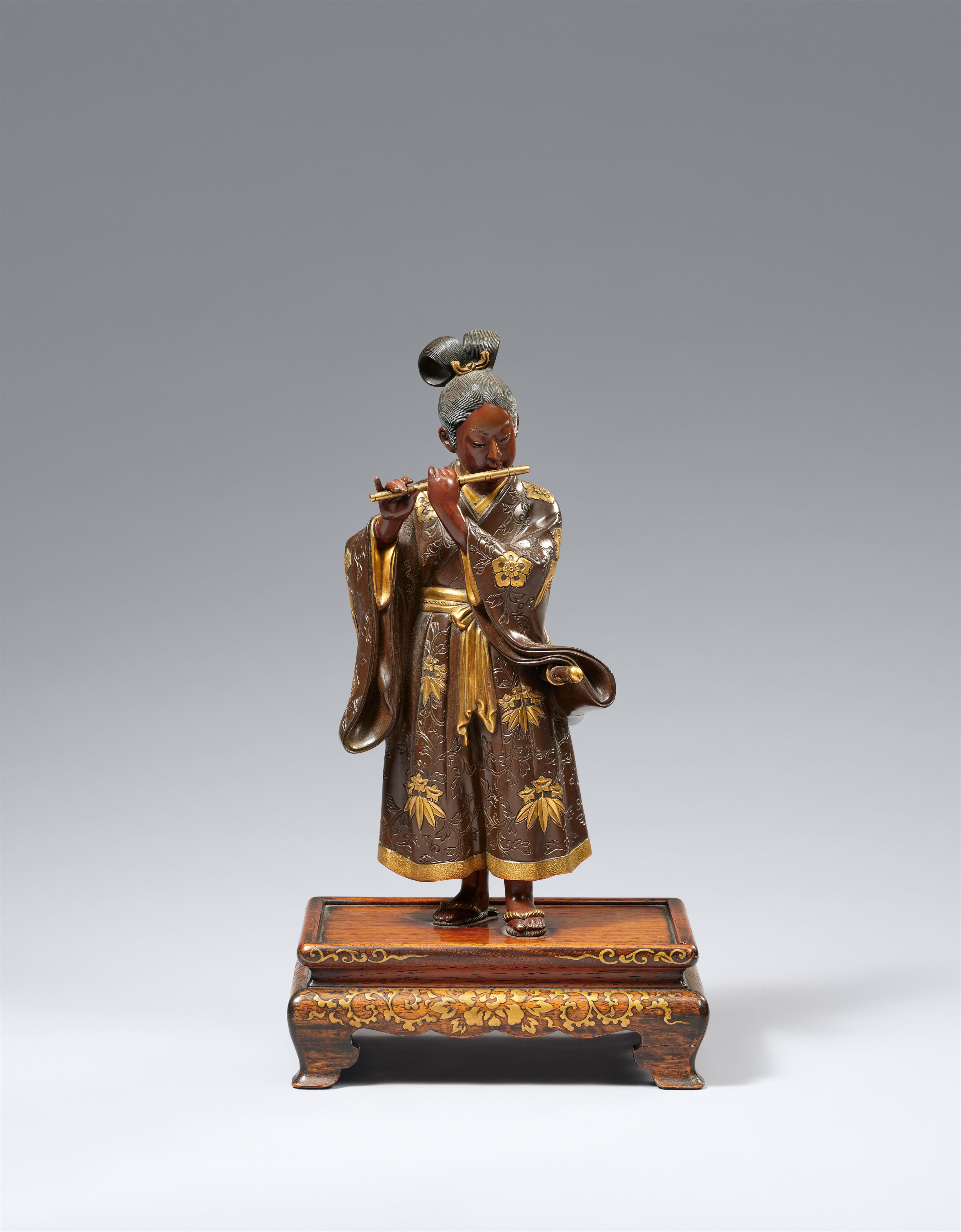 A Miyao bronze figure of a young samurai playing the flute. Bronze and gilding. Late 19th century - image-1