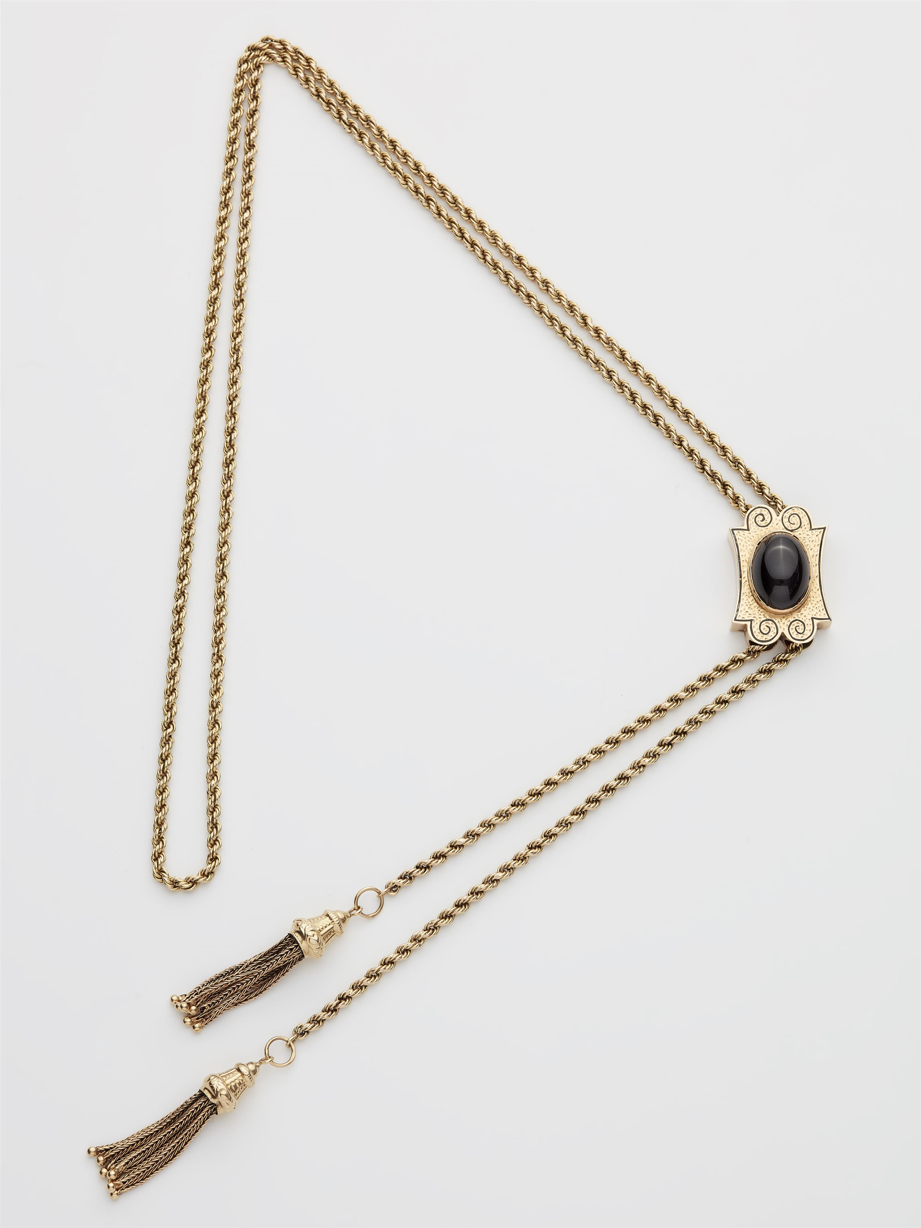 A Victorian 14k gold black enamel and carbuncle long chain with slider. - image-1