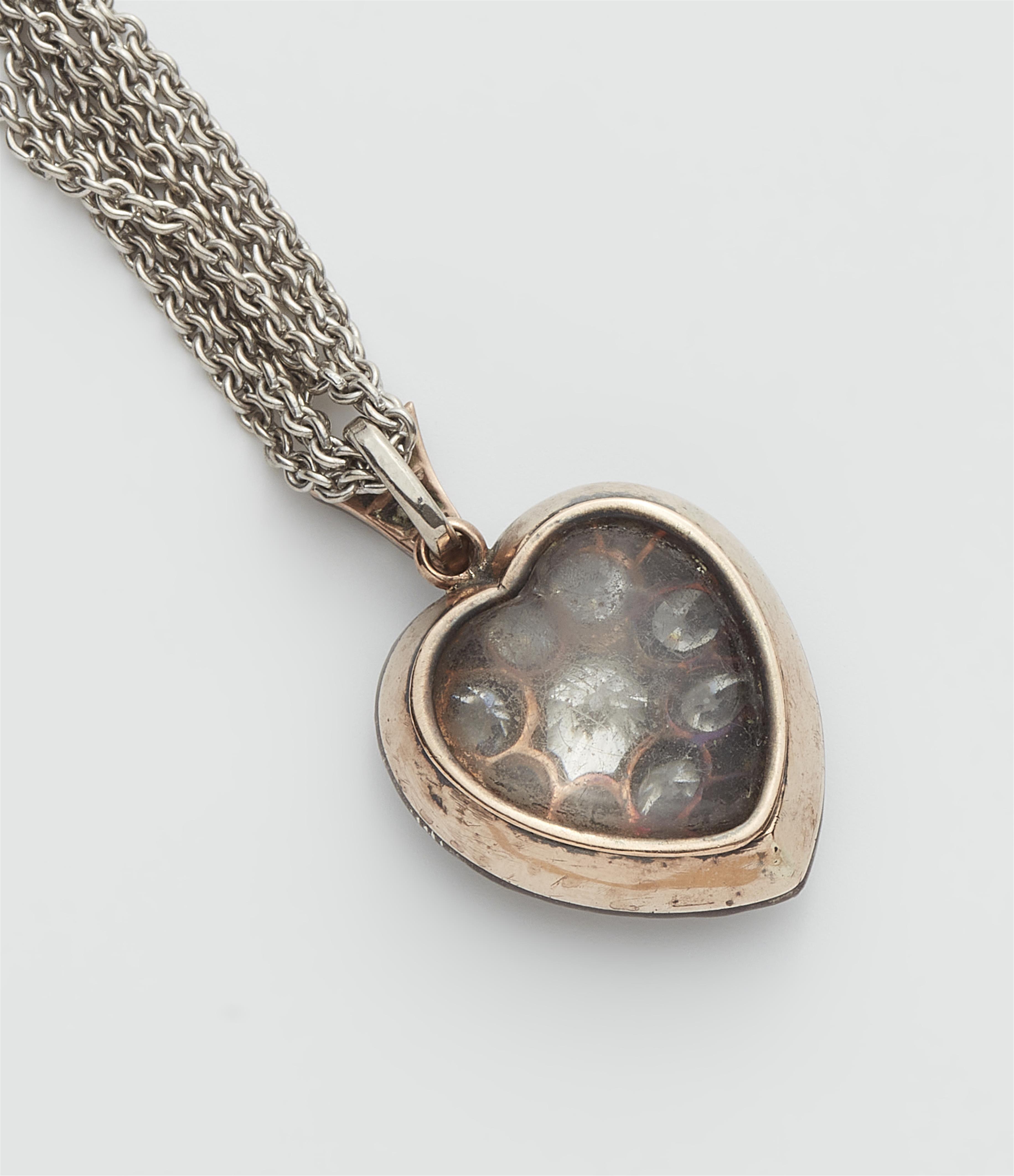 A Victorian silver 14k red gold and diamond heart locket with attached 14k white gold chain. - image-2