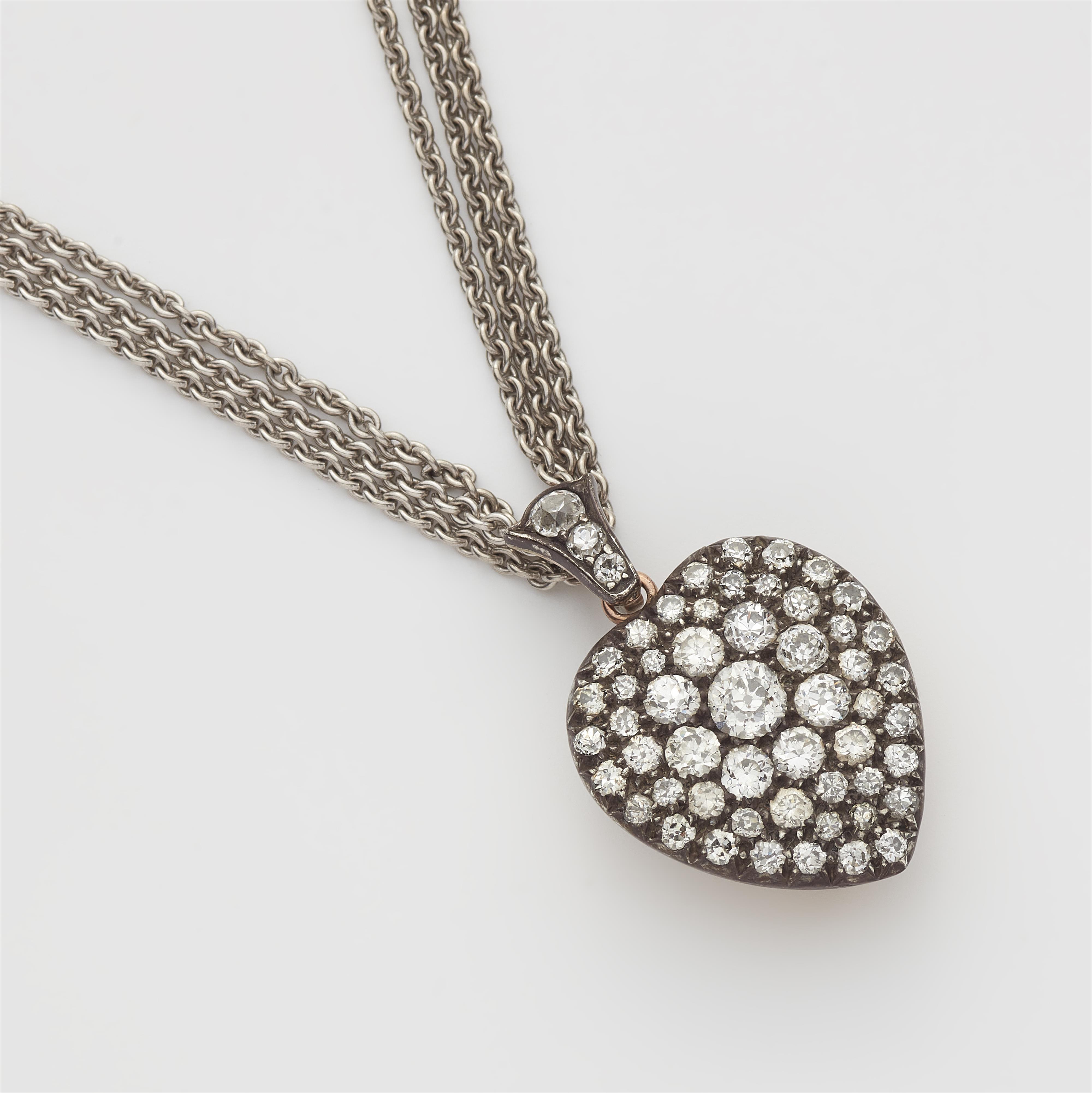 A Victorian silver 14k red gold and diamond heart locket with attached 14k white gold chain. - image-1