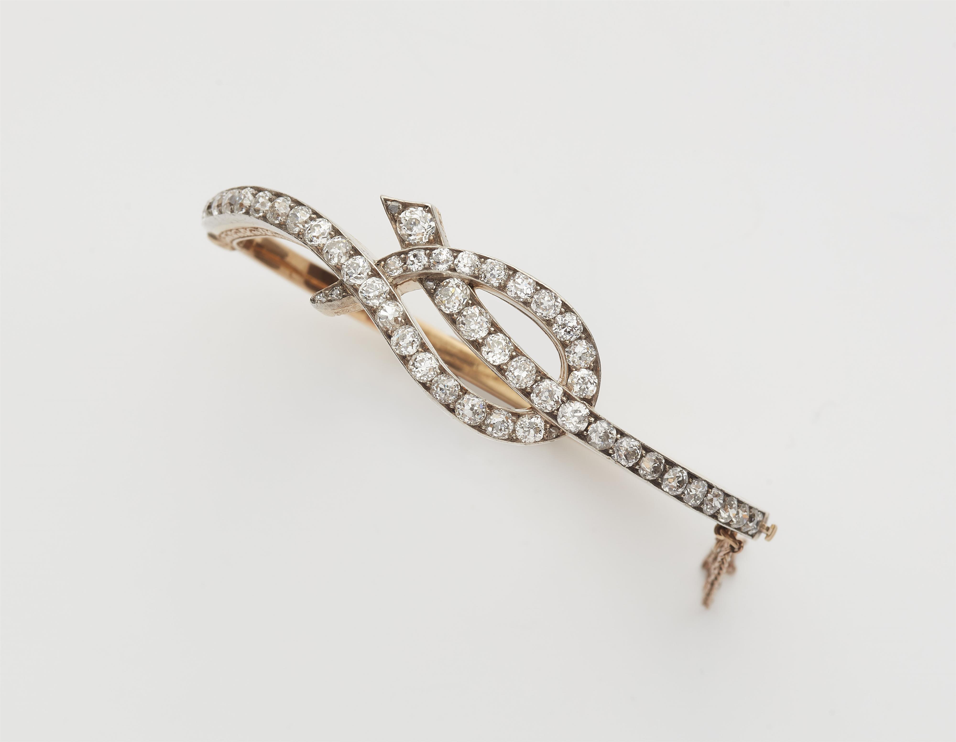 A platinum 18kt gold and diamond Belle Epoque bangle. - image-1