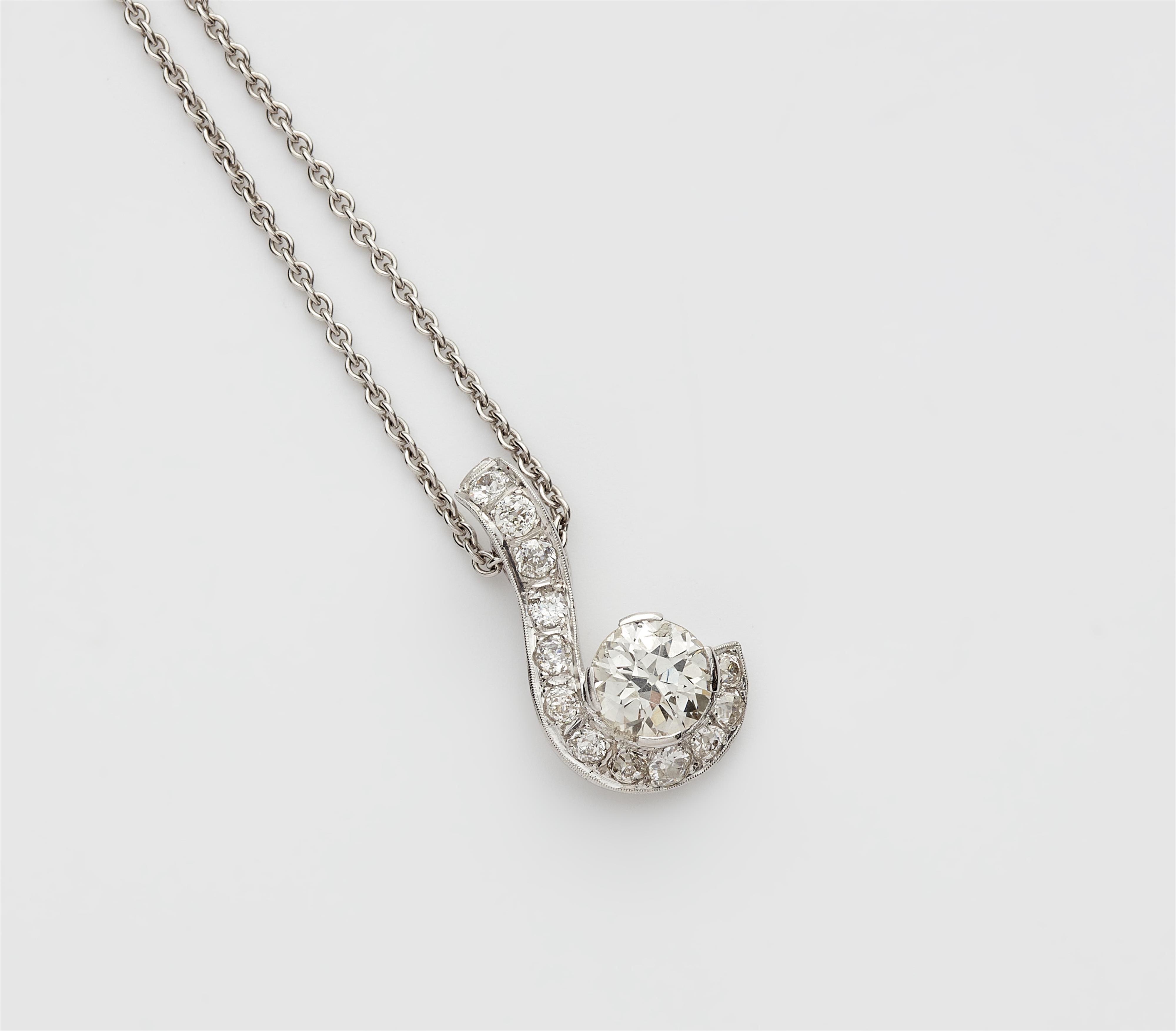 An 18k white gold and diamond pendant with 14k gold chain. - image-1