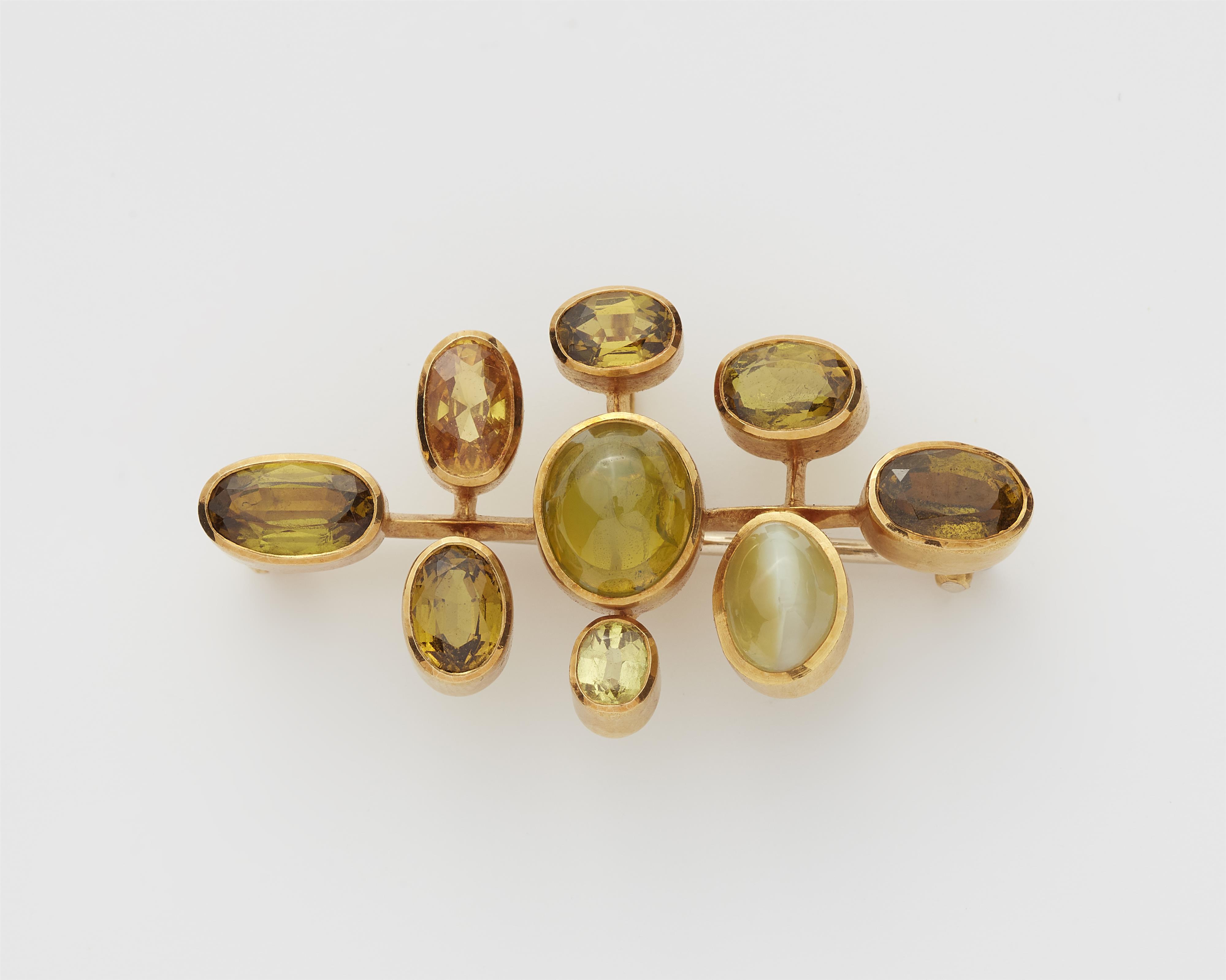 A German 18k gold chrysoberyl and sapphire brooch. - image-1