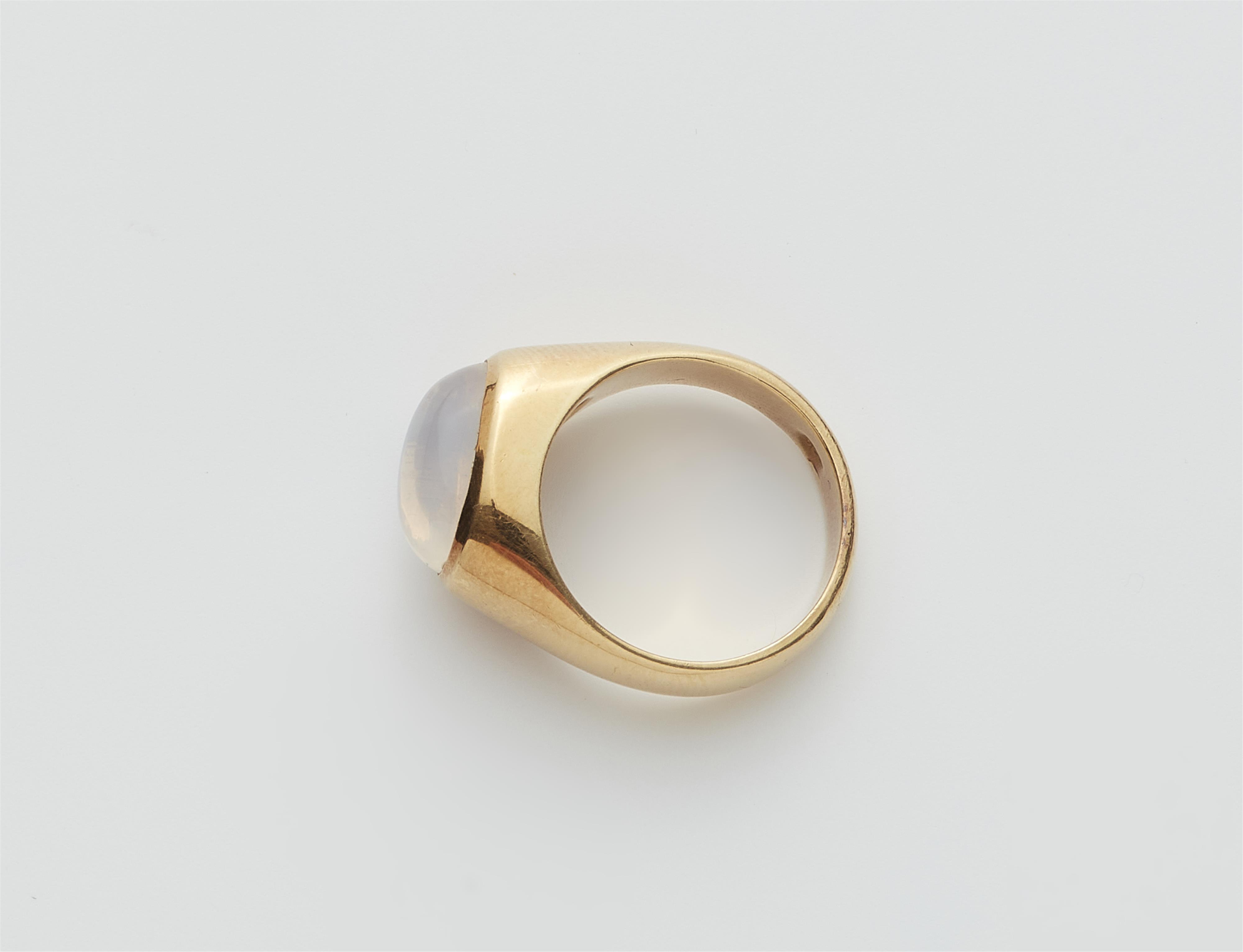 A German 18 kt gold and moonstone cabochon band ring. - image-2