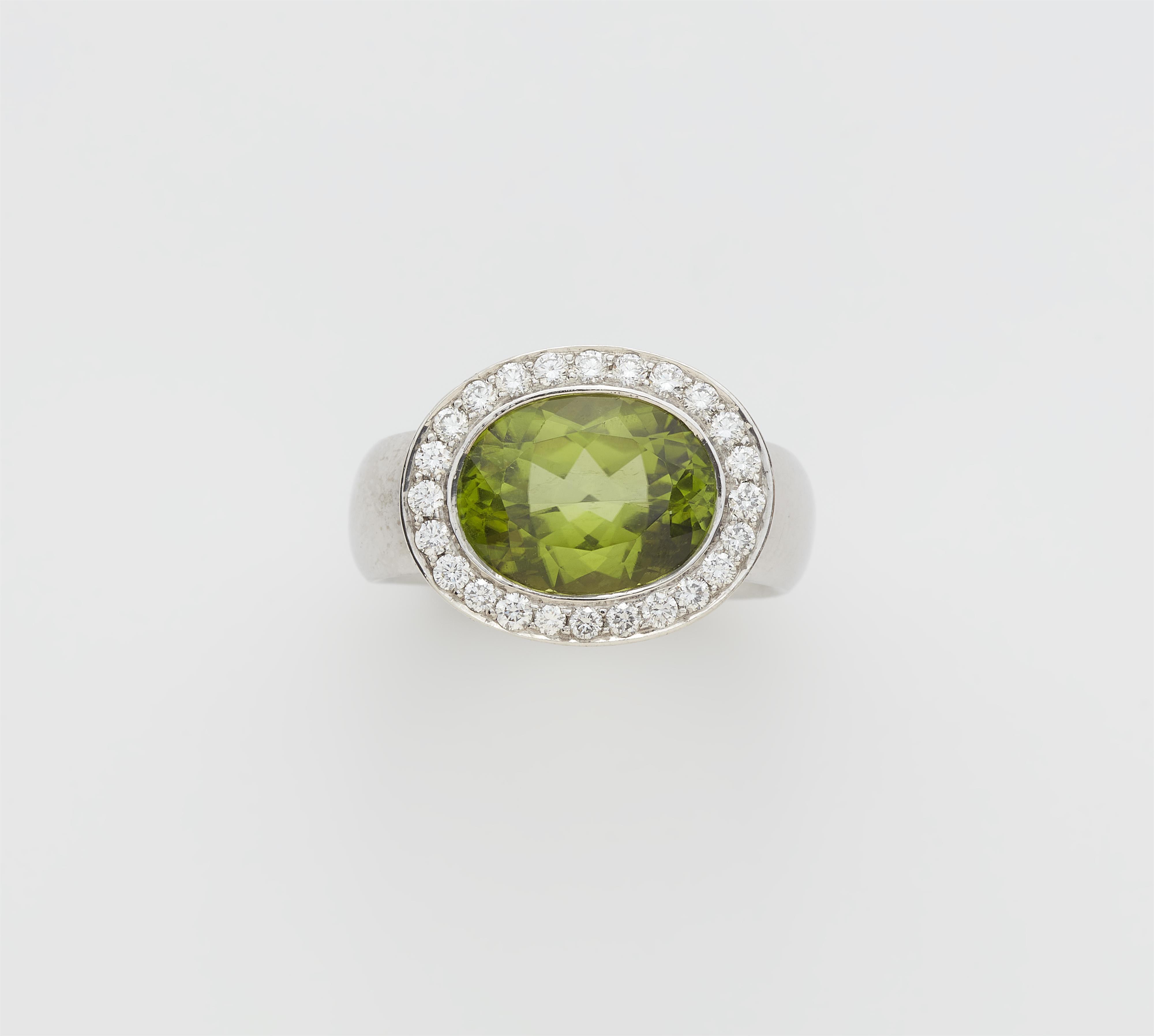 A German 18k white gold, diamond and peridot cluster ring. - image-1