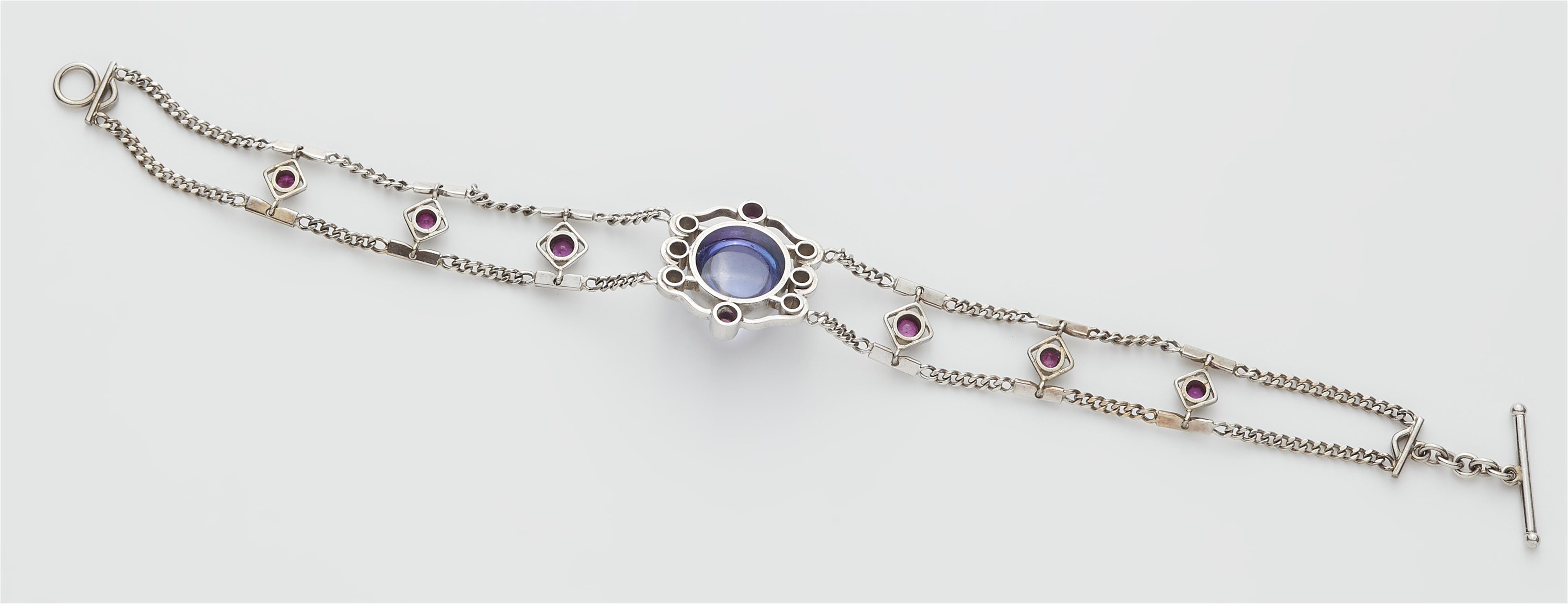 A German 18k white gold tanzanite ruby and diamond bracelet. - image-3