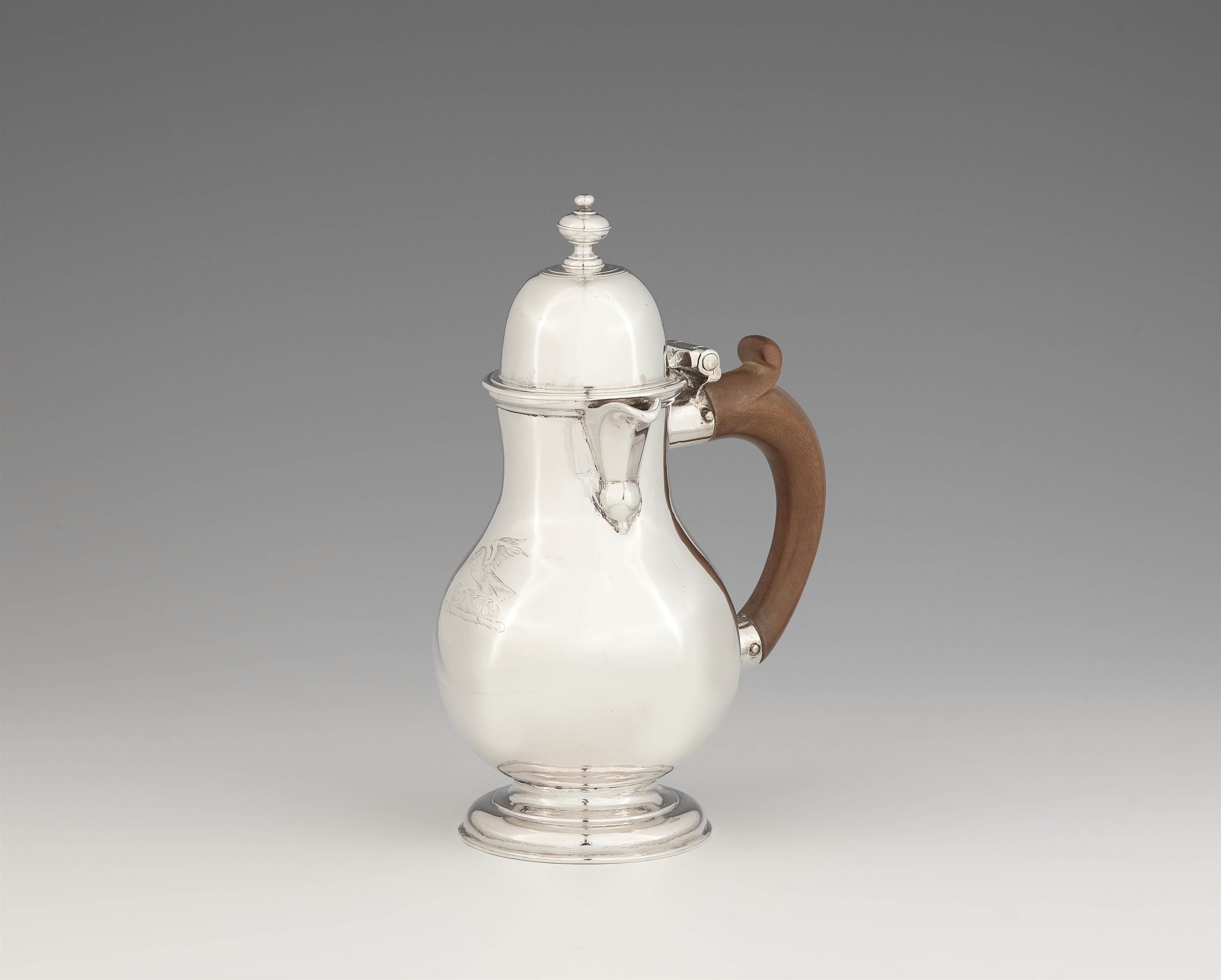 A George I silver hot milk jug - image-1