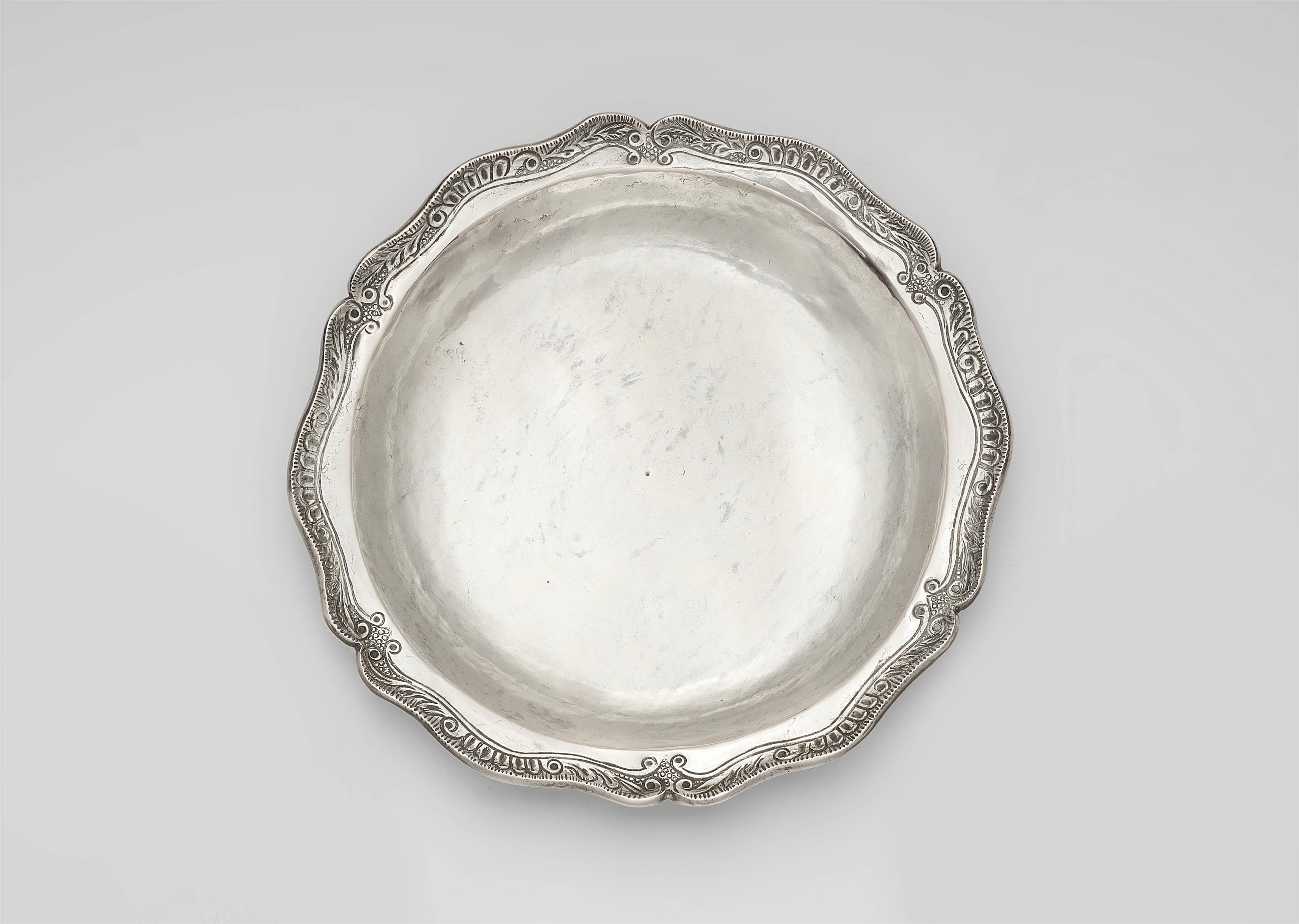 A silver plate with a relief border - image-1