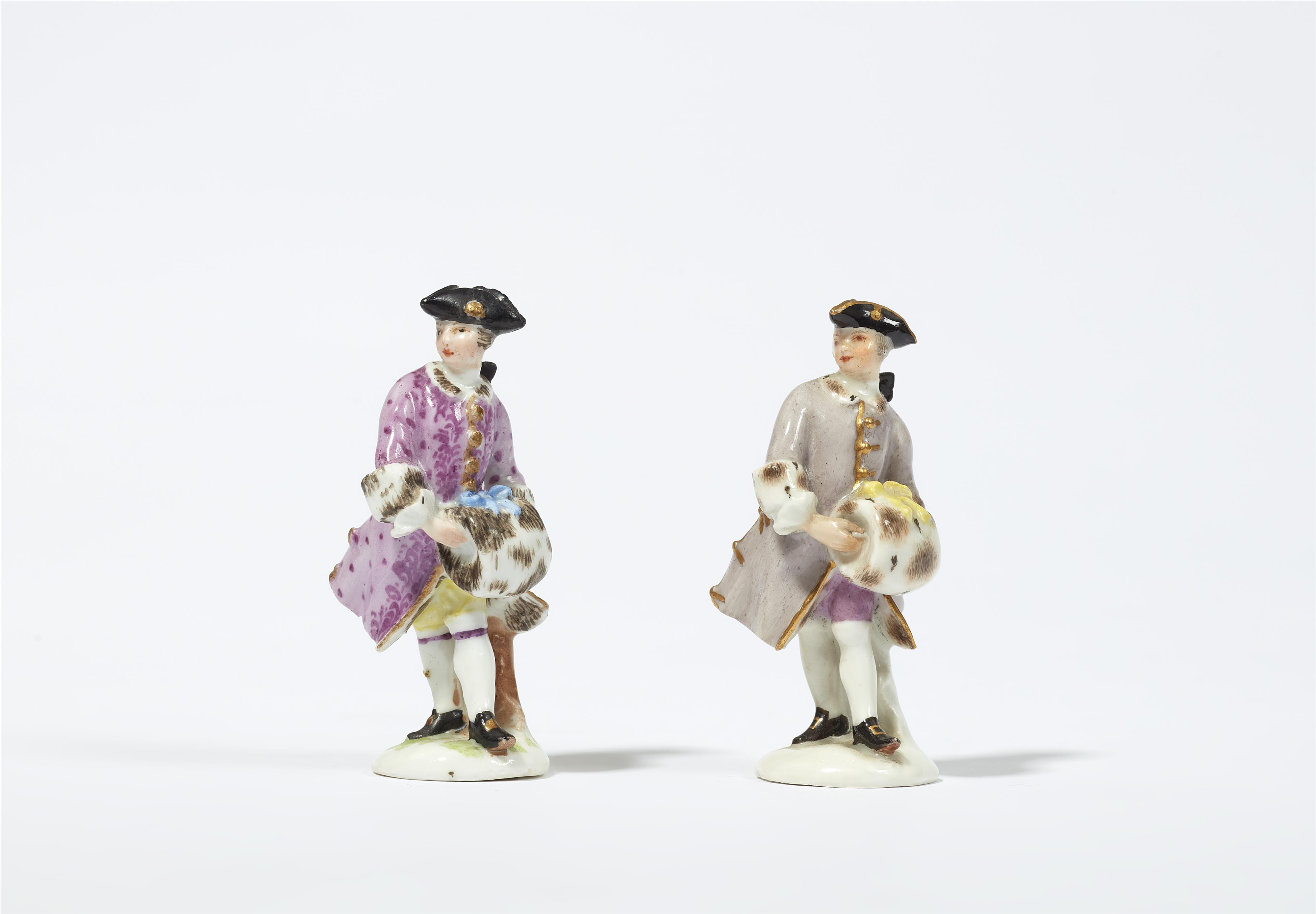 Two miniature Meissen porcelain figures of men with muffs - image-1