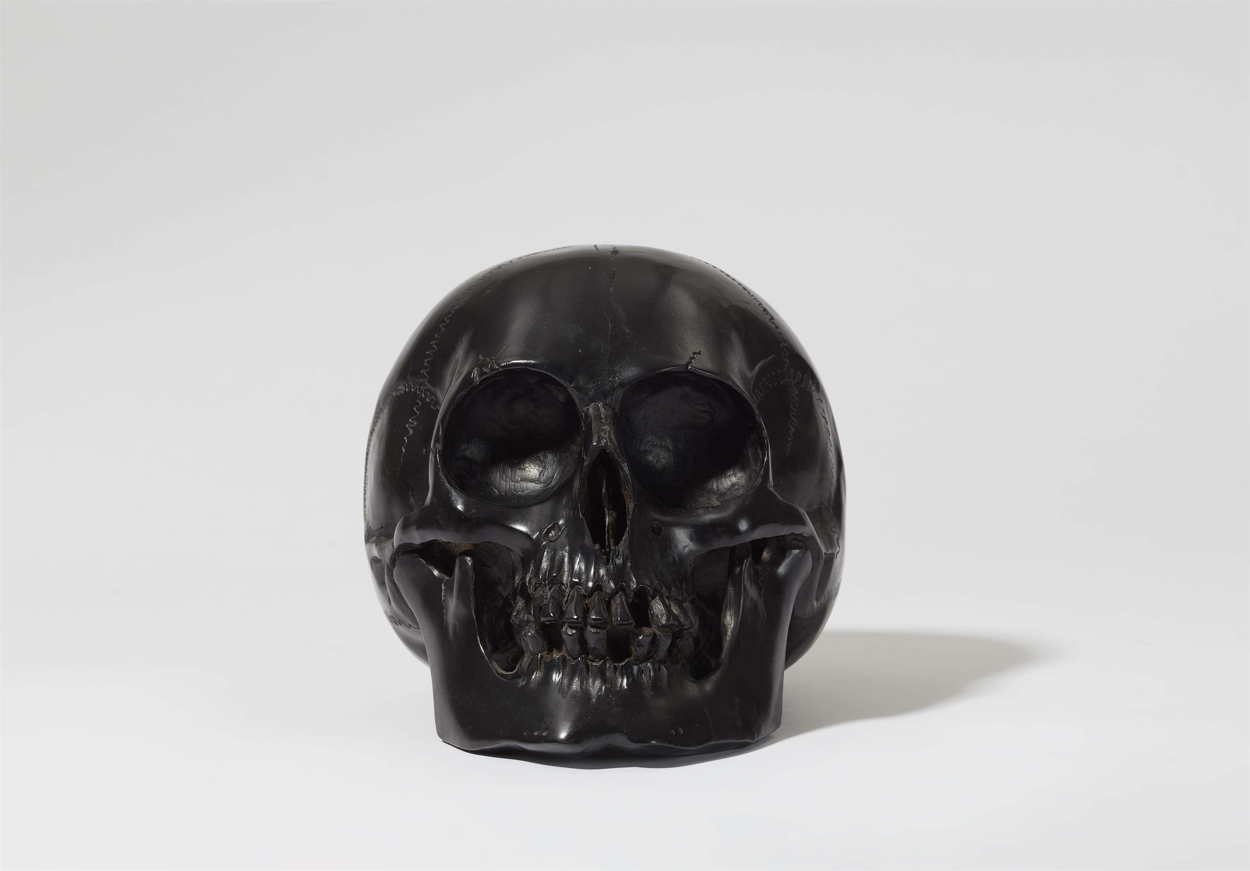 A carved ebony skull - image-1