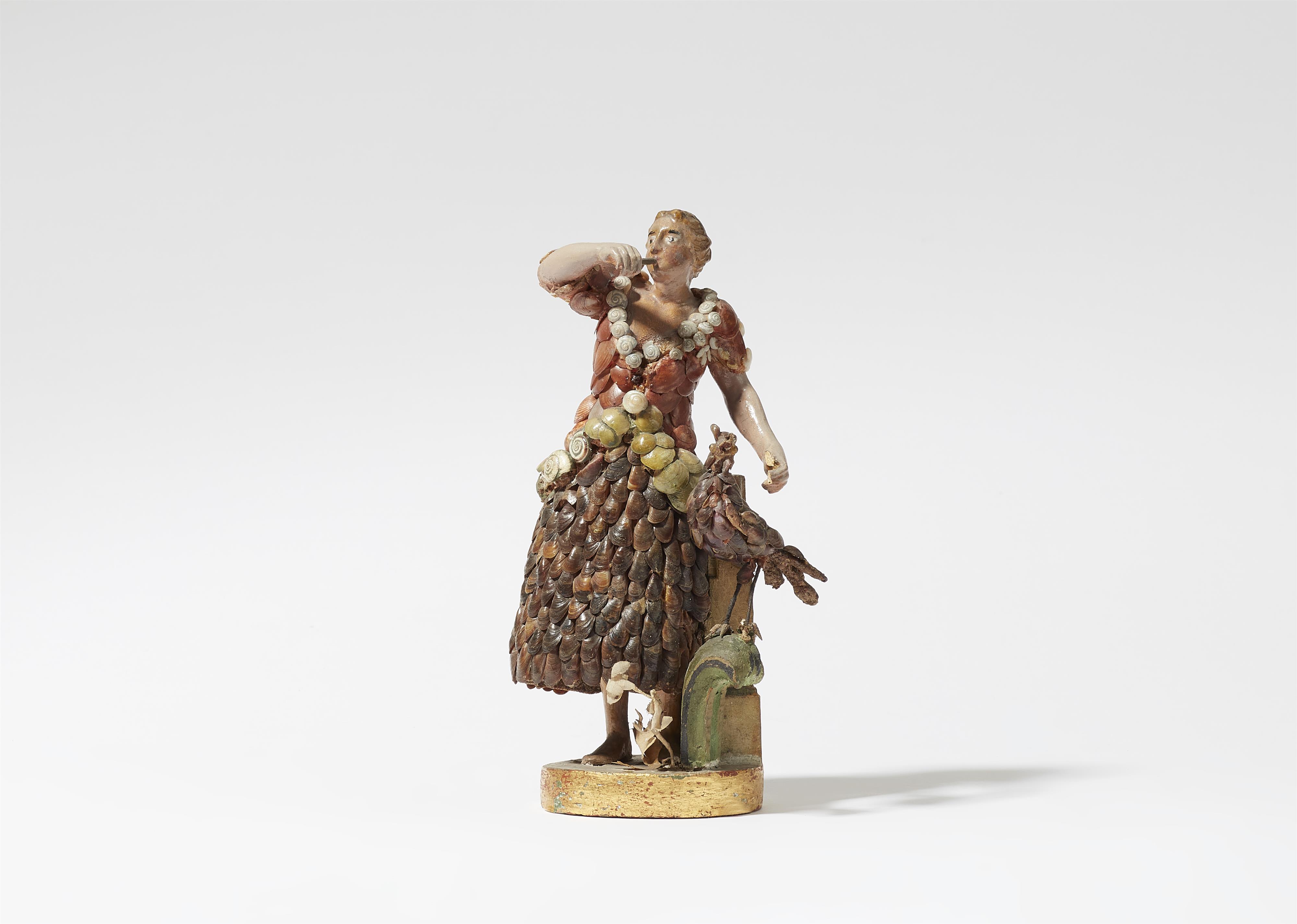 A figure of a lady playing the flute with a bird - image-1