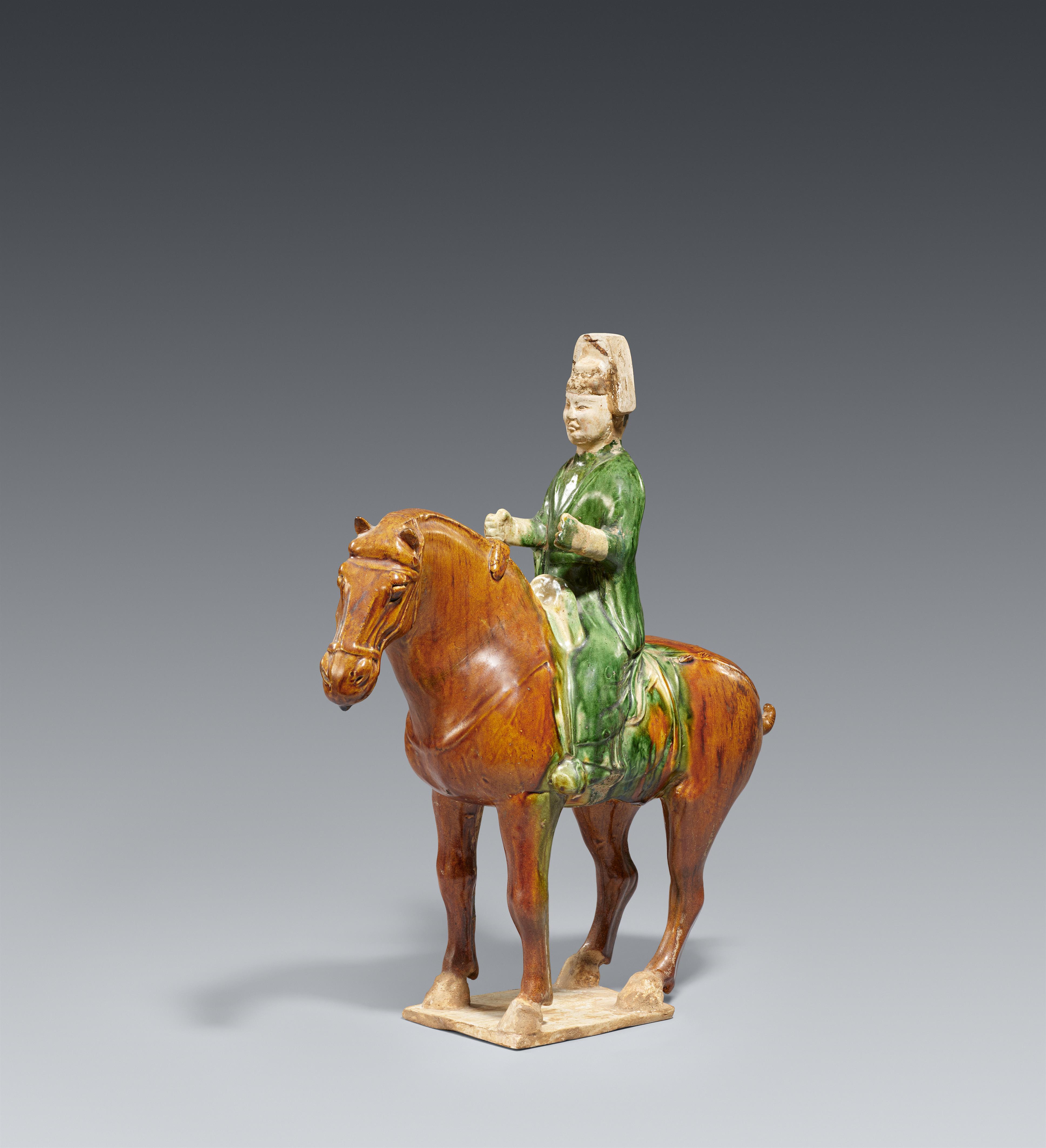 A sancai-glazed figure of a horse and rider. Tang dynasty (618-907) - image-1
