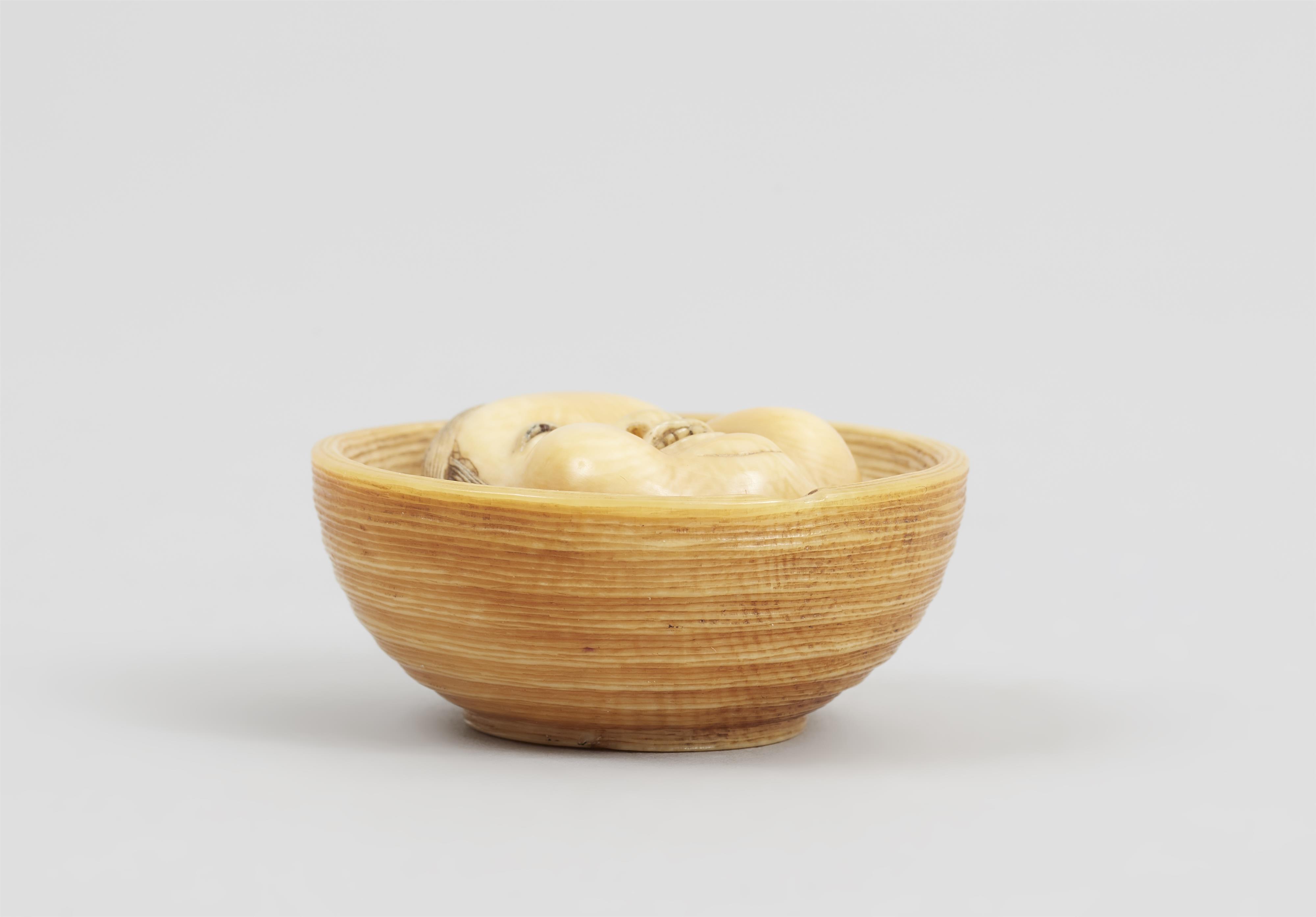 An Osaka lightly stained ivory netsuke of a Otafuku mask in a bowl. Mid-19th century - image-4