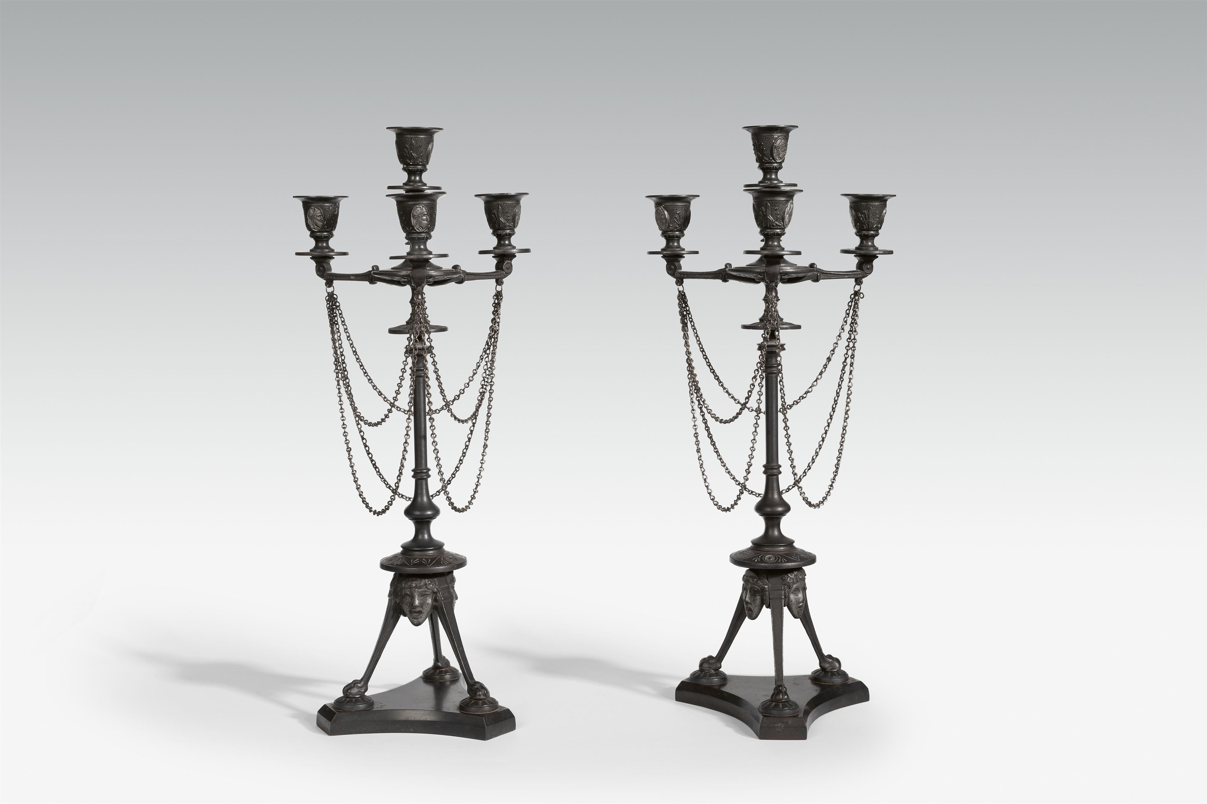 A pair of four flame cast iron candelabra - image-1