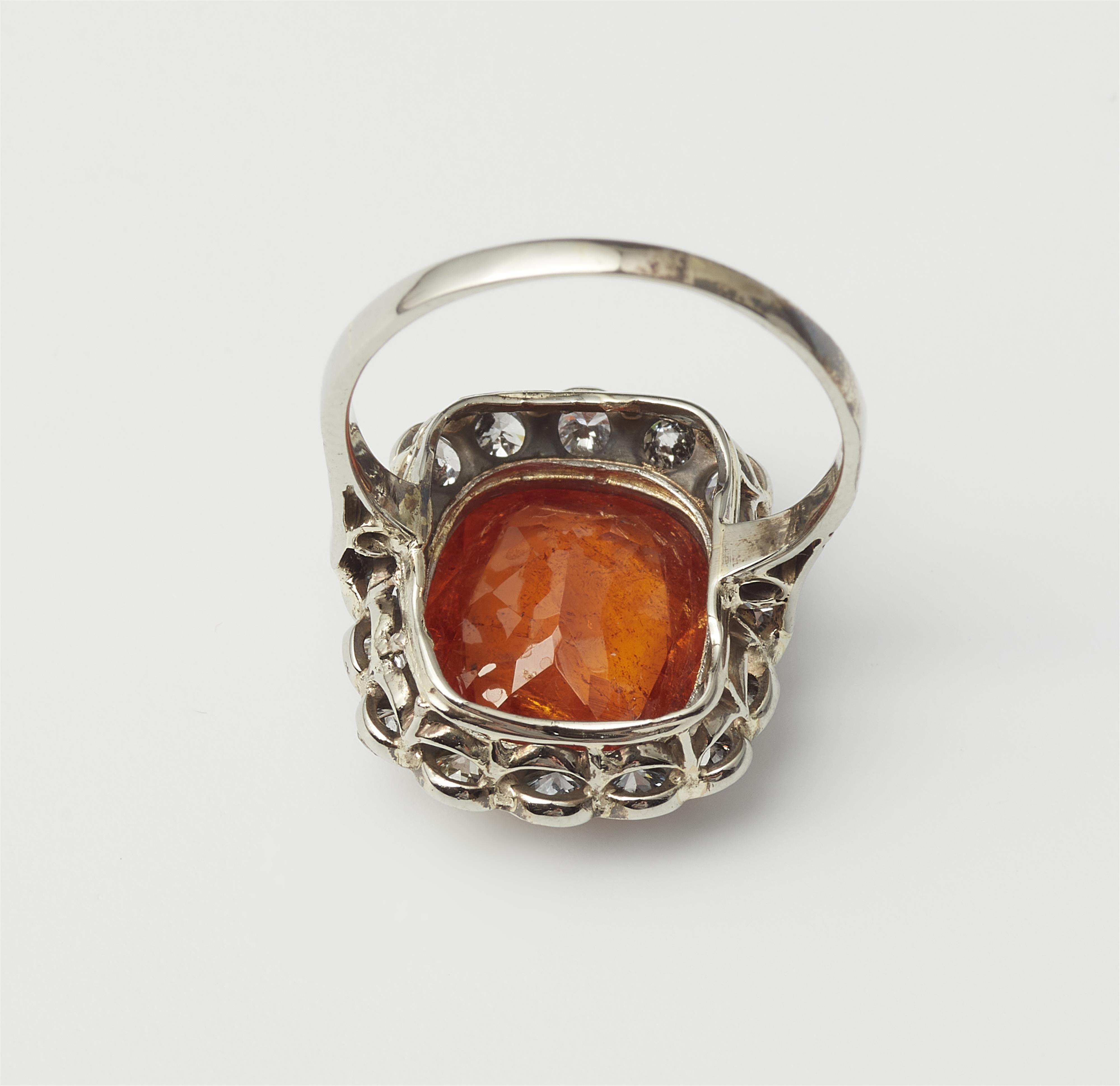 An Art Déco platinum, diamond and spessartine cluster ring. - image-2