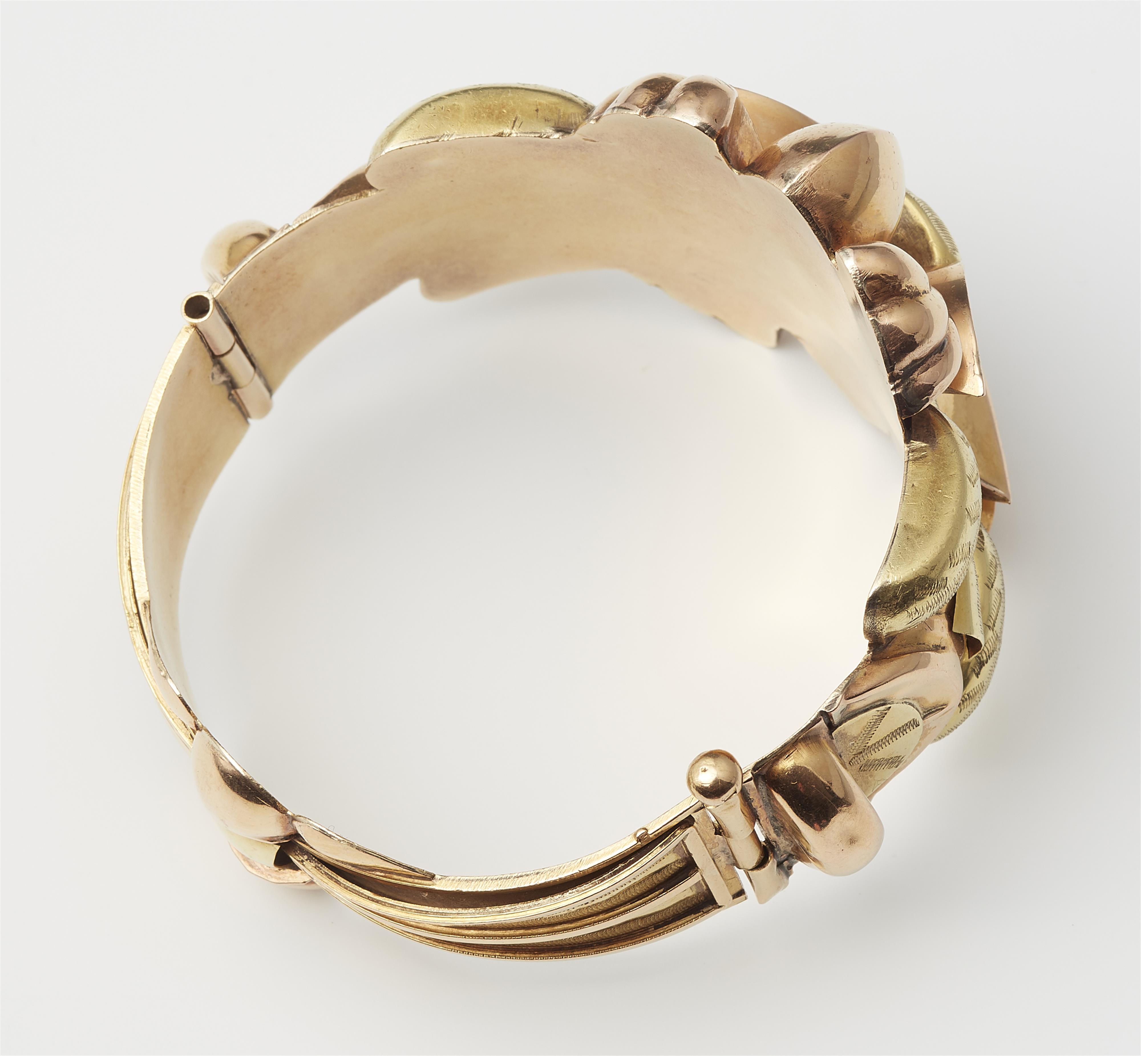 A Tunesian 18k bicolour gold repoussé Retro Style bangle. - image-2