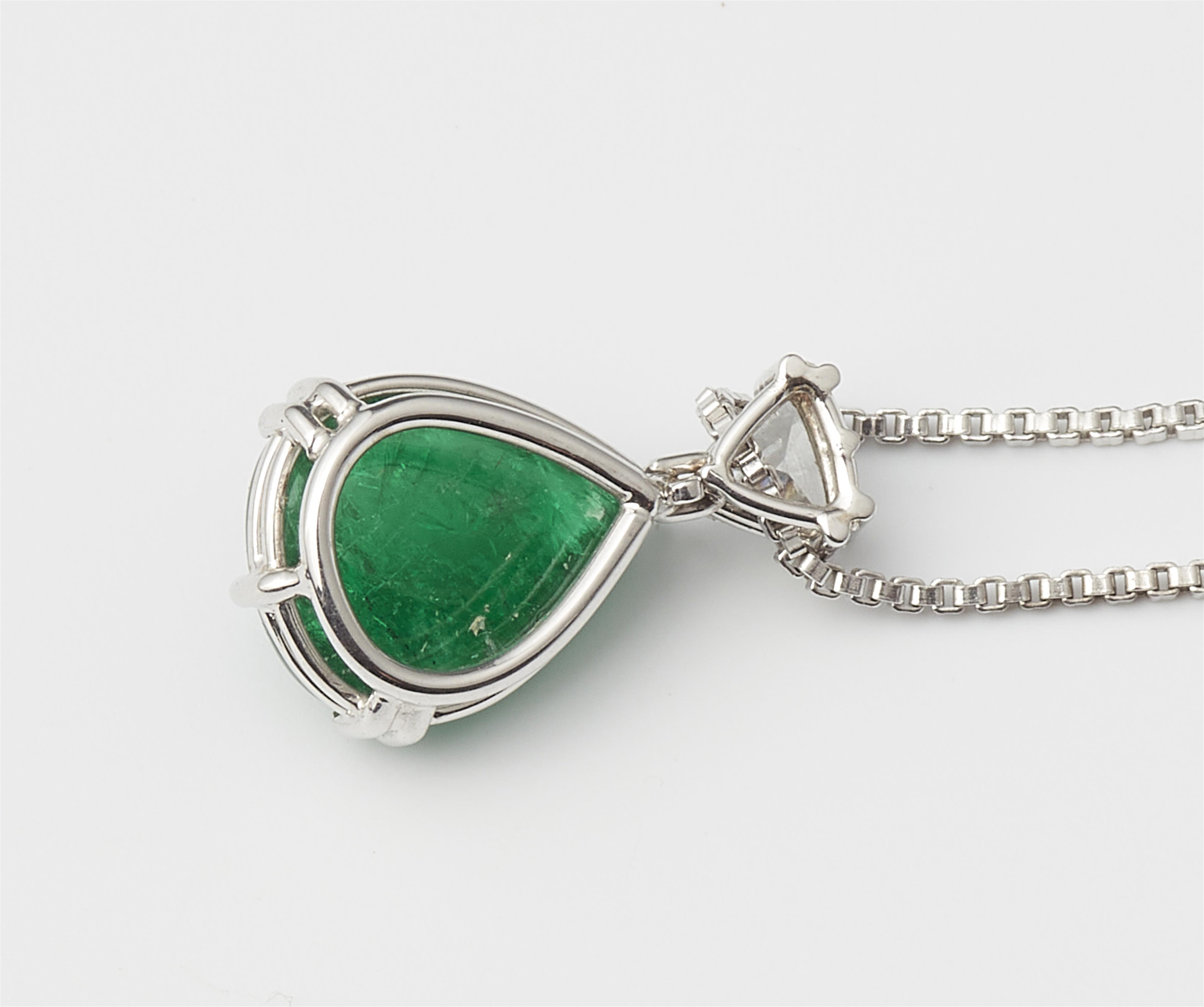 An 18k white gold triangle-cut diamond and Sandawana emerald cabochon drop pendant with attached chain. - image-2