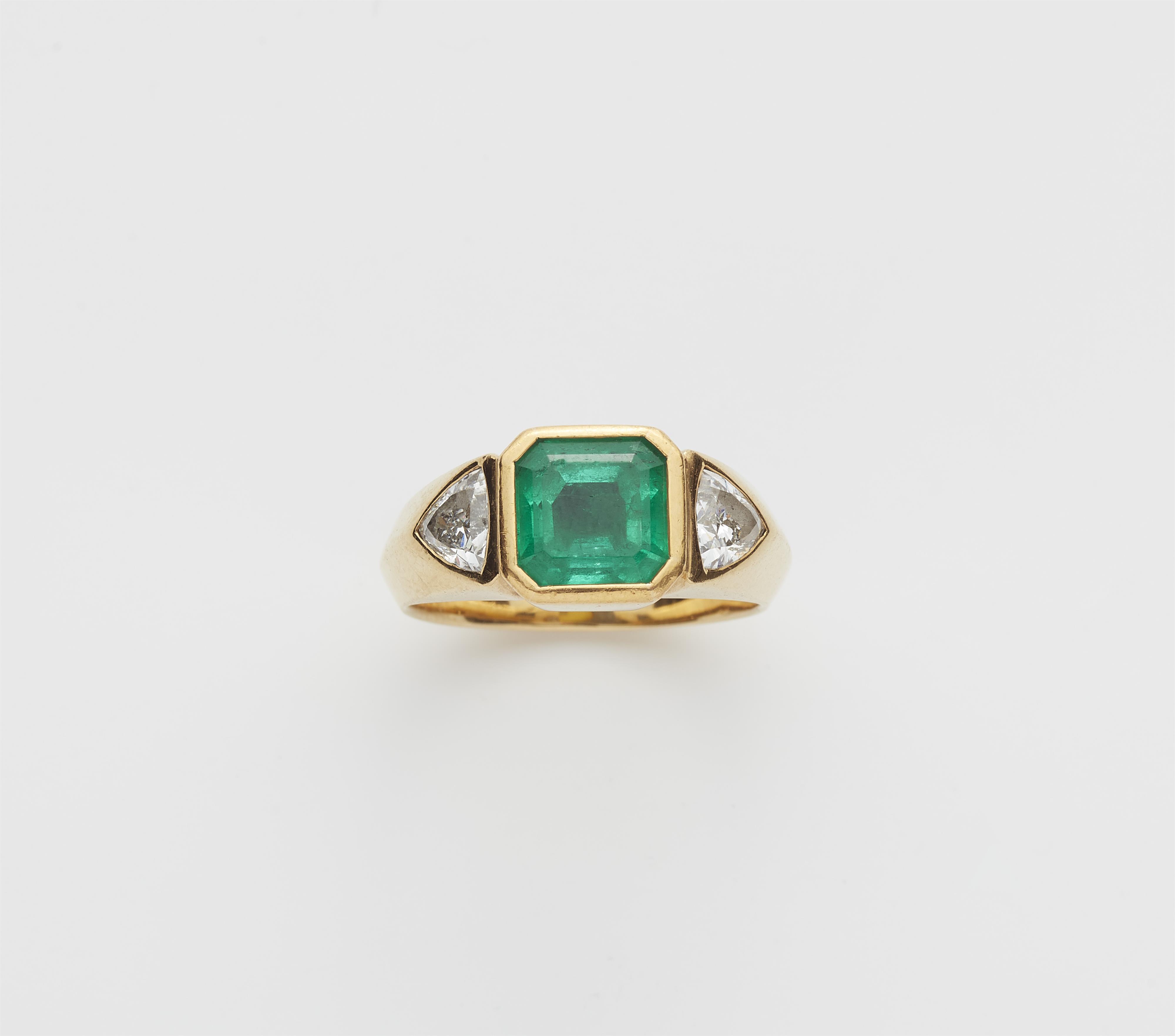 A German 18k gold diamond and Columbian emerald three stone ring. - image-1