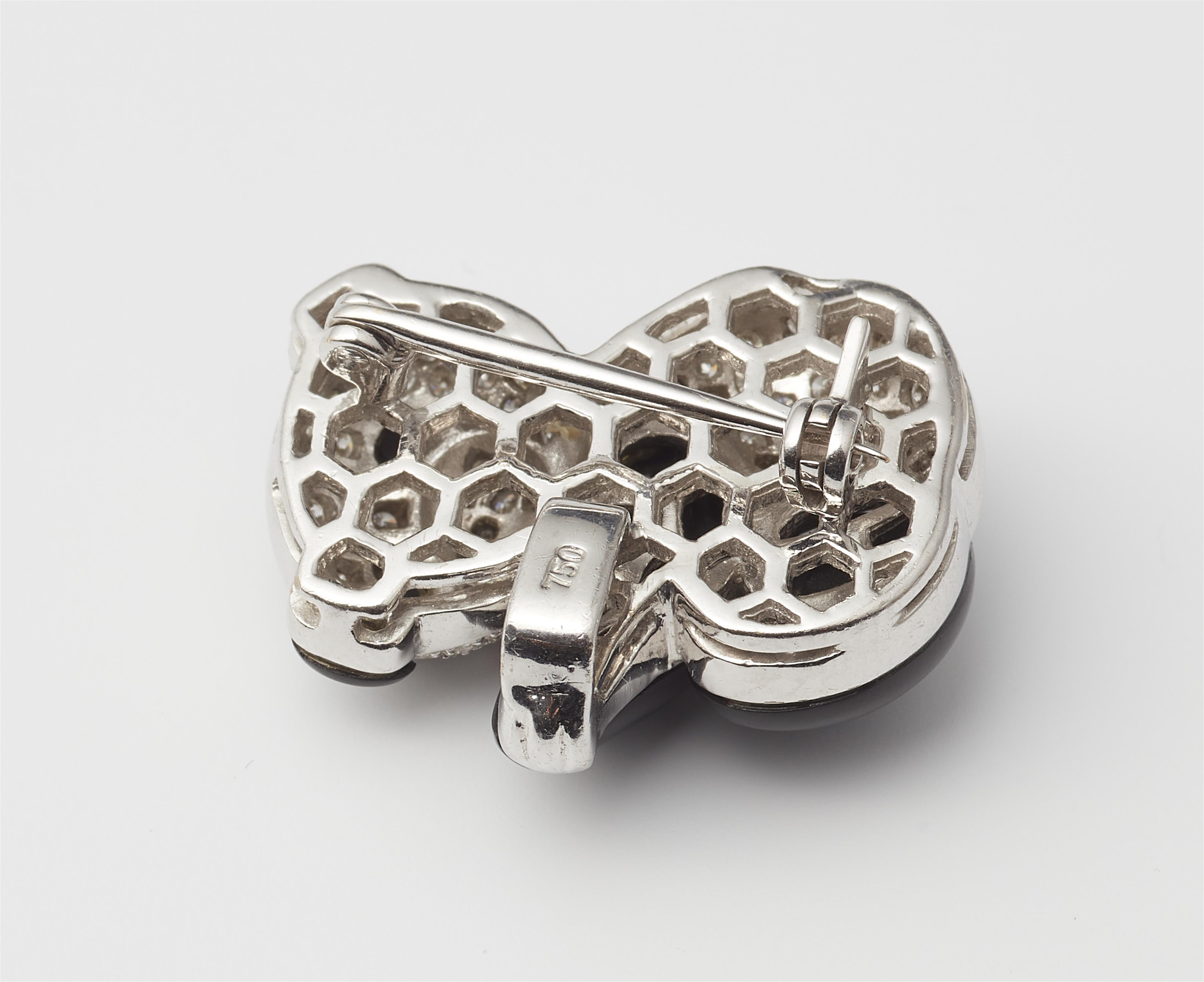 A small 18k white gold onyx and diamond panda brooch, can also be worn as a pendant. - image-2