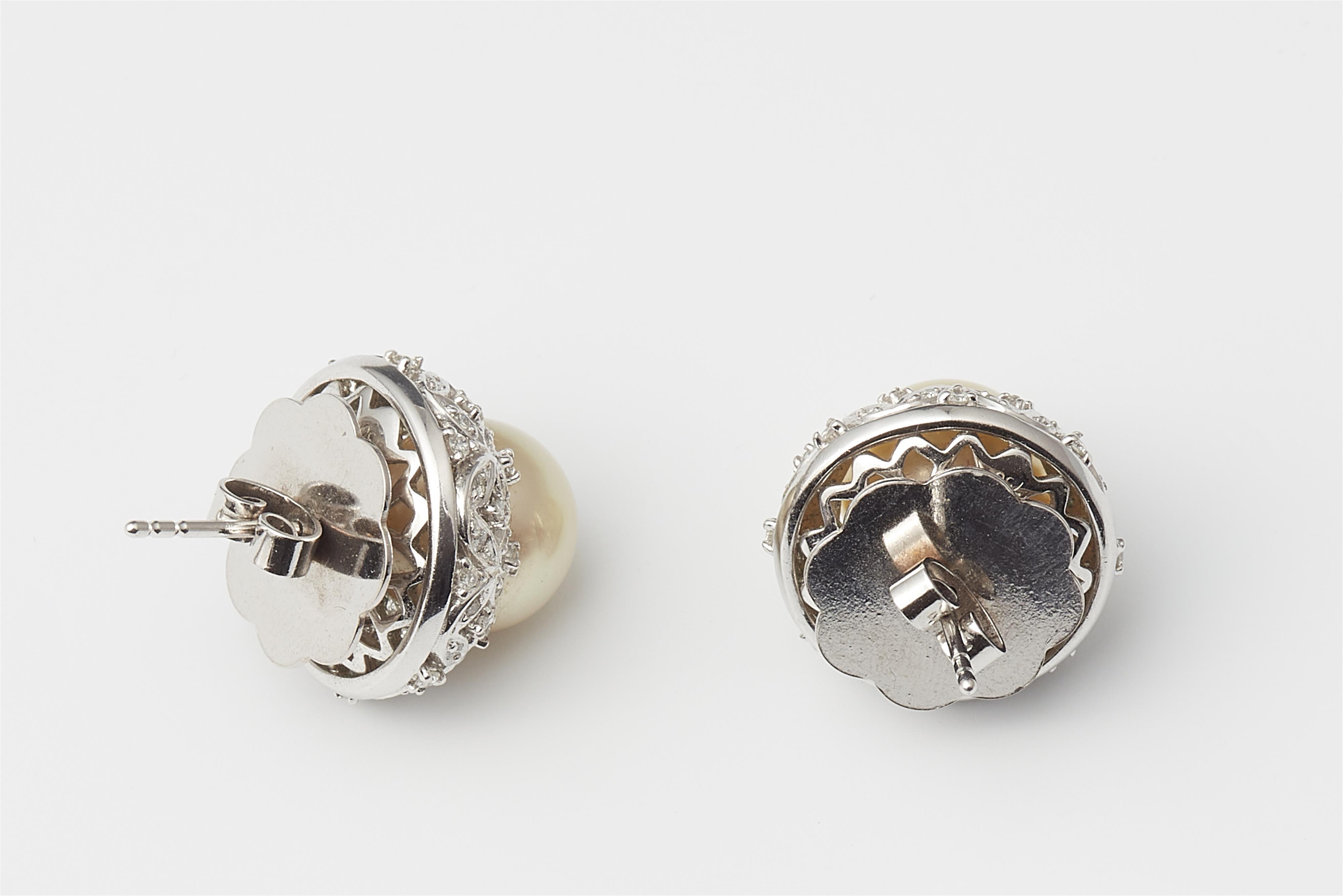 A pair of 14k white gold diamond and cultured pearl stud earrings. - image-2