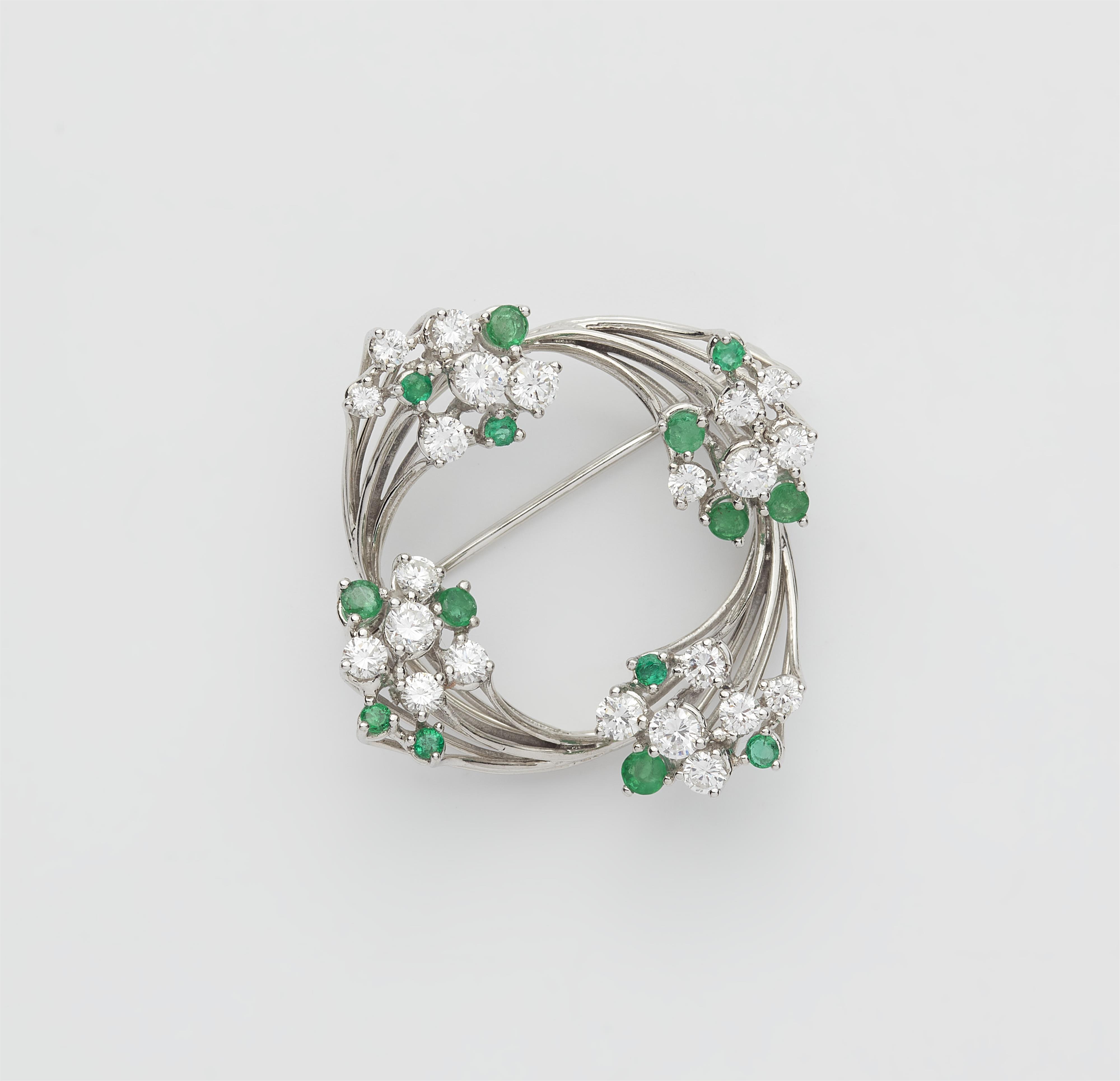 A Dutch 14k white gold diamond and emerald wreath brooch. - image-1