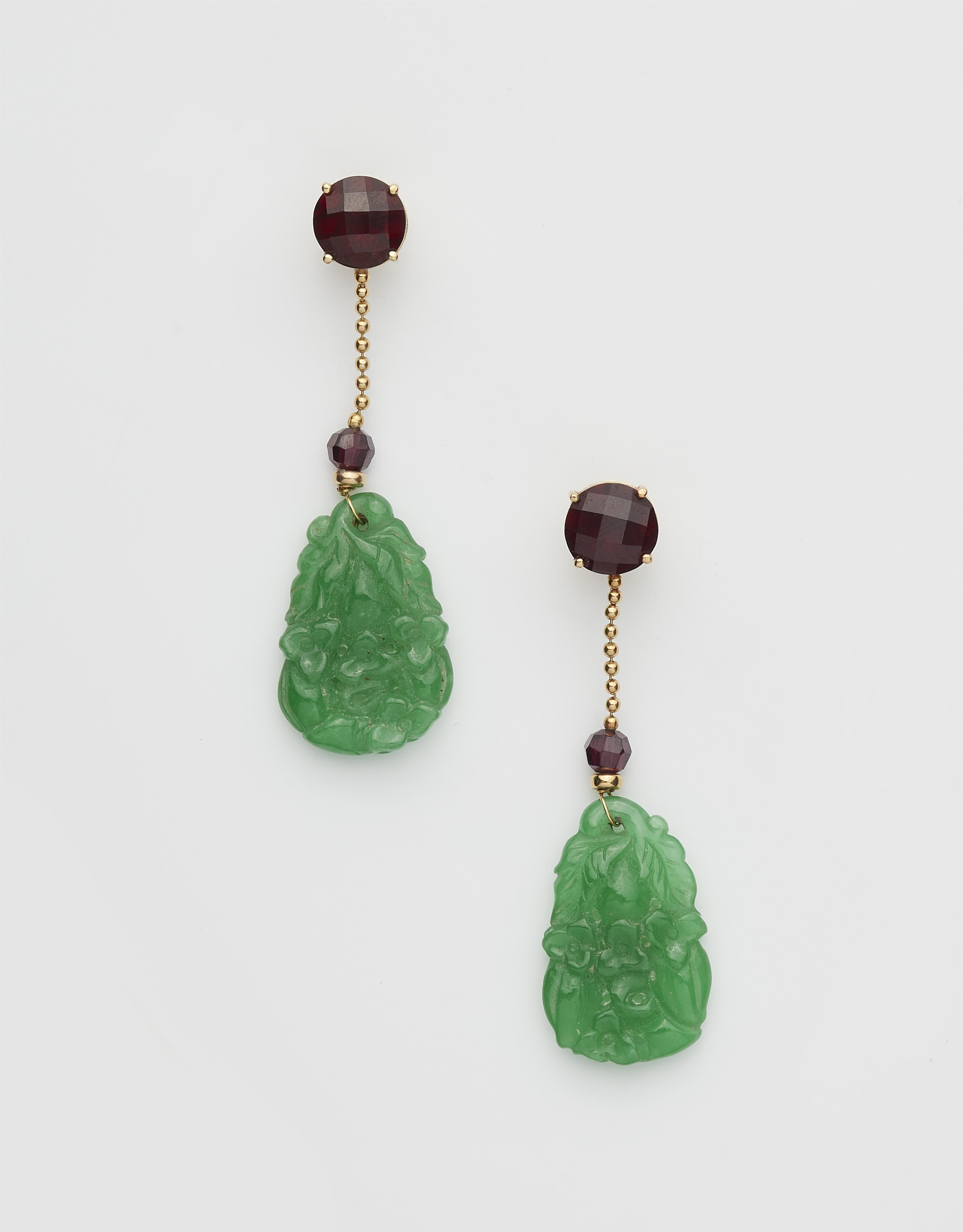 A pair of German 18k gold garnet and carved Burmese jade earrings. - image-1
