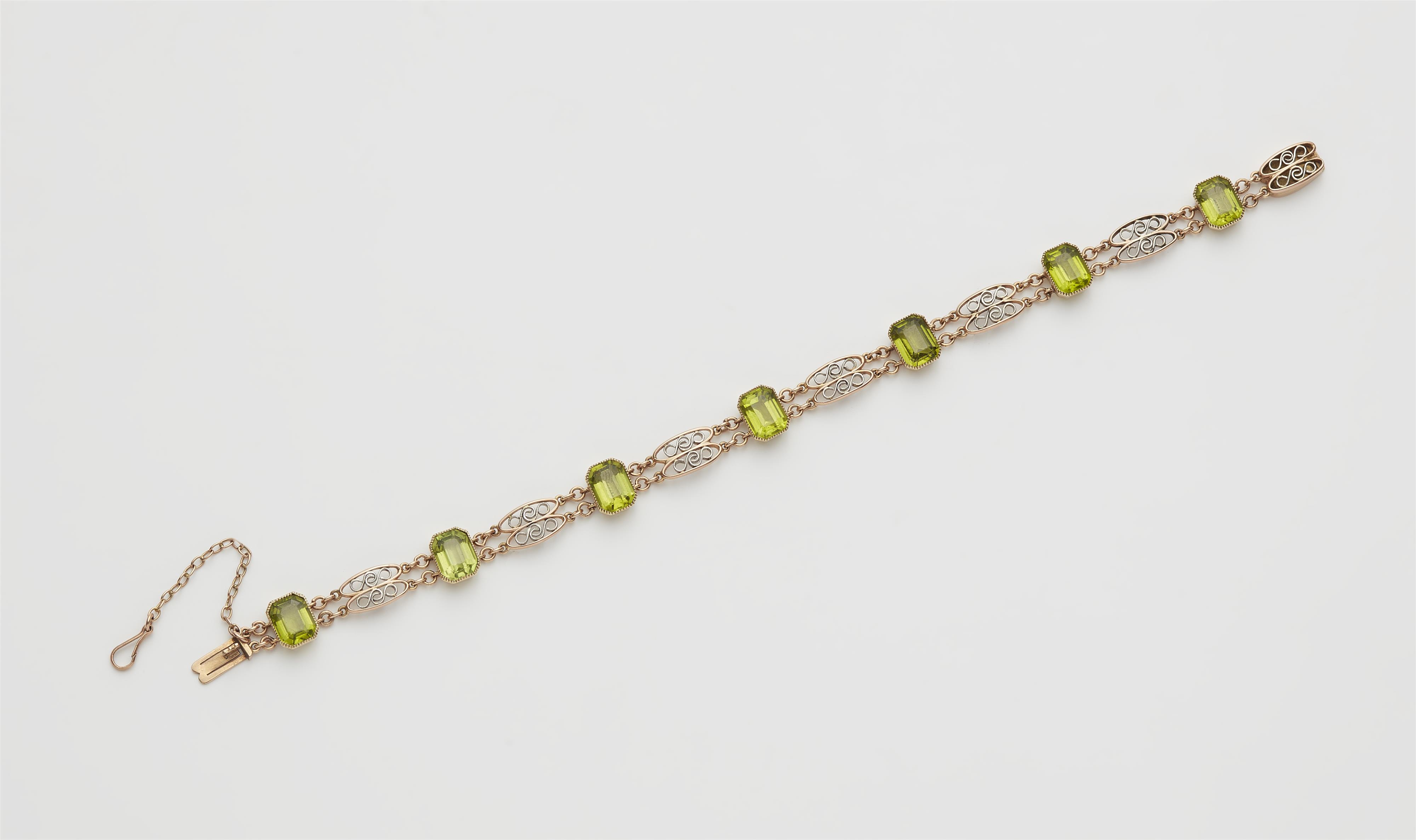 A 14k red gold platinum and peridot bracelet. - image-1