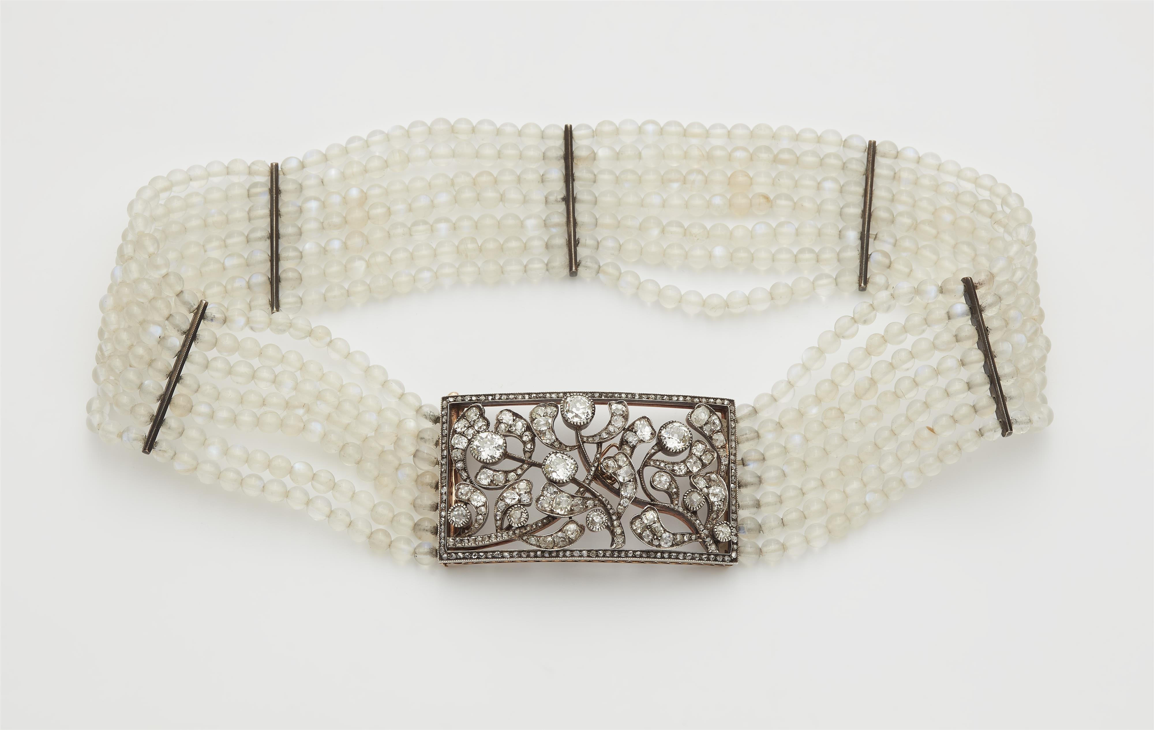 A silver and moonstone choker necklace with a Belle Epoque silver 14k red gold and diamond convertable clasp which can also be worn as a brooch with attached needle. - image-1