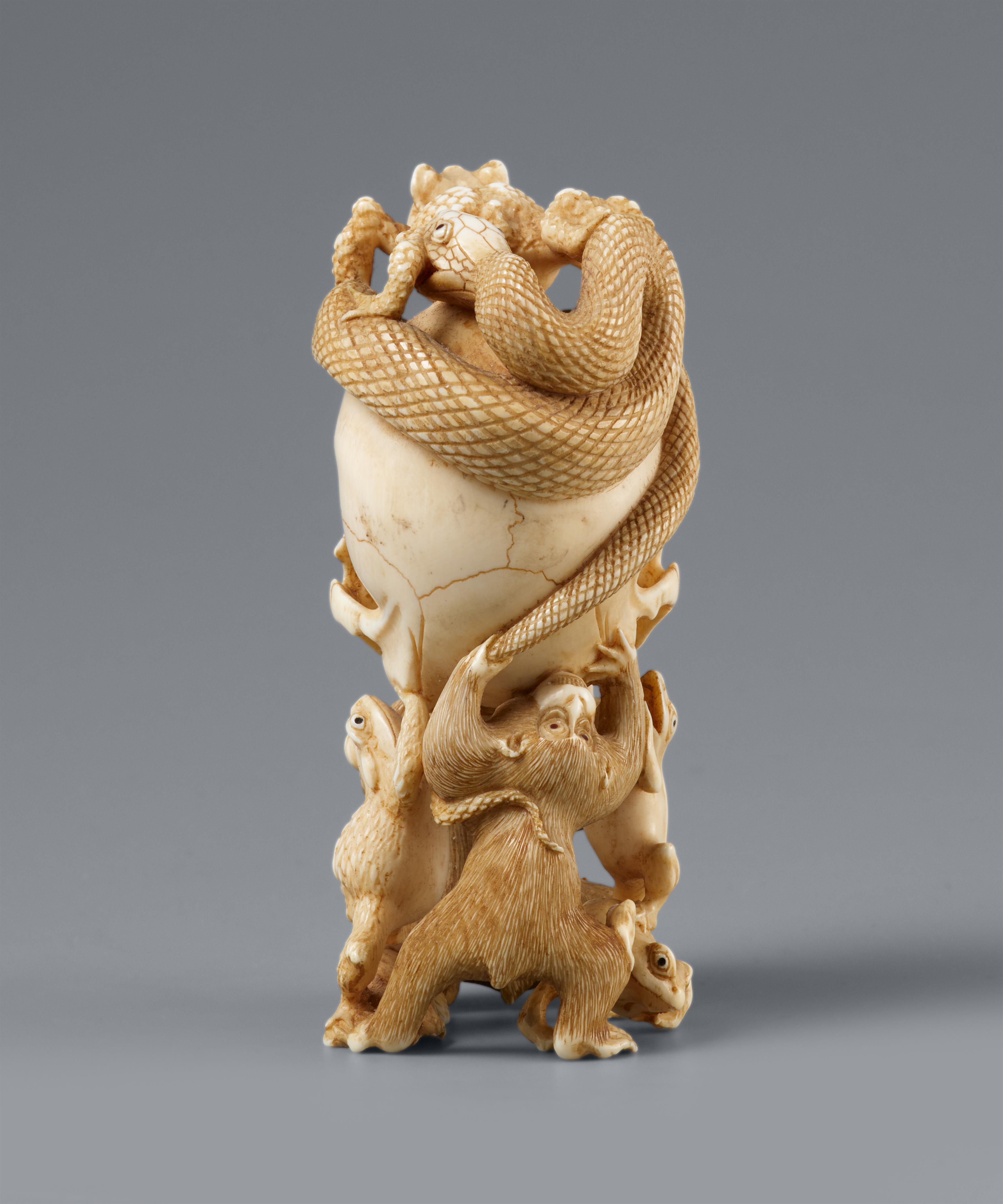 An ivory okimono of a skull with snake and frogs. Late 19th century - image-2