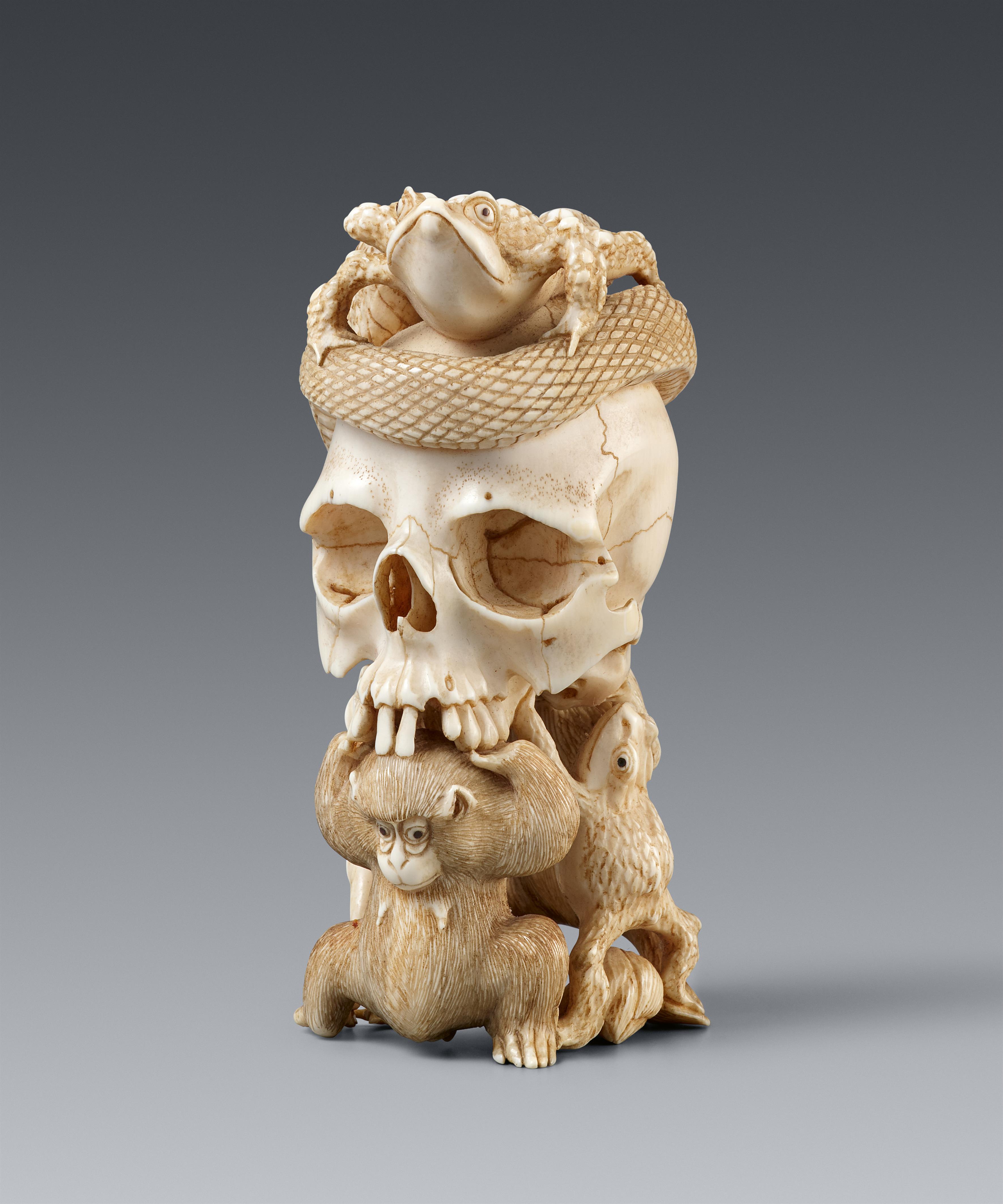 An ivory okimono of a skull with snake and frogs. Late 19th century - image-1