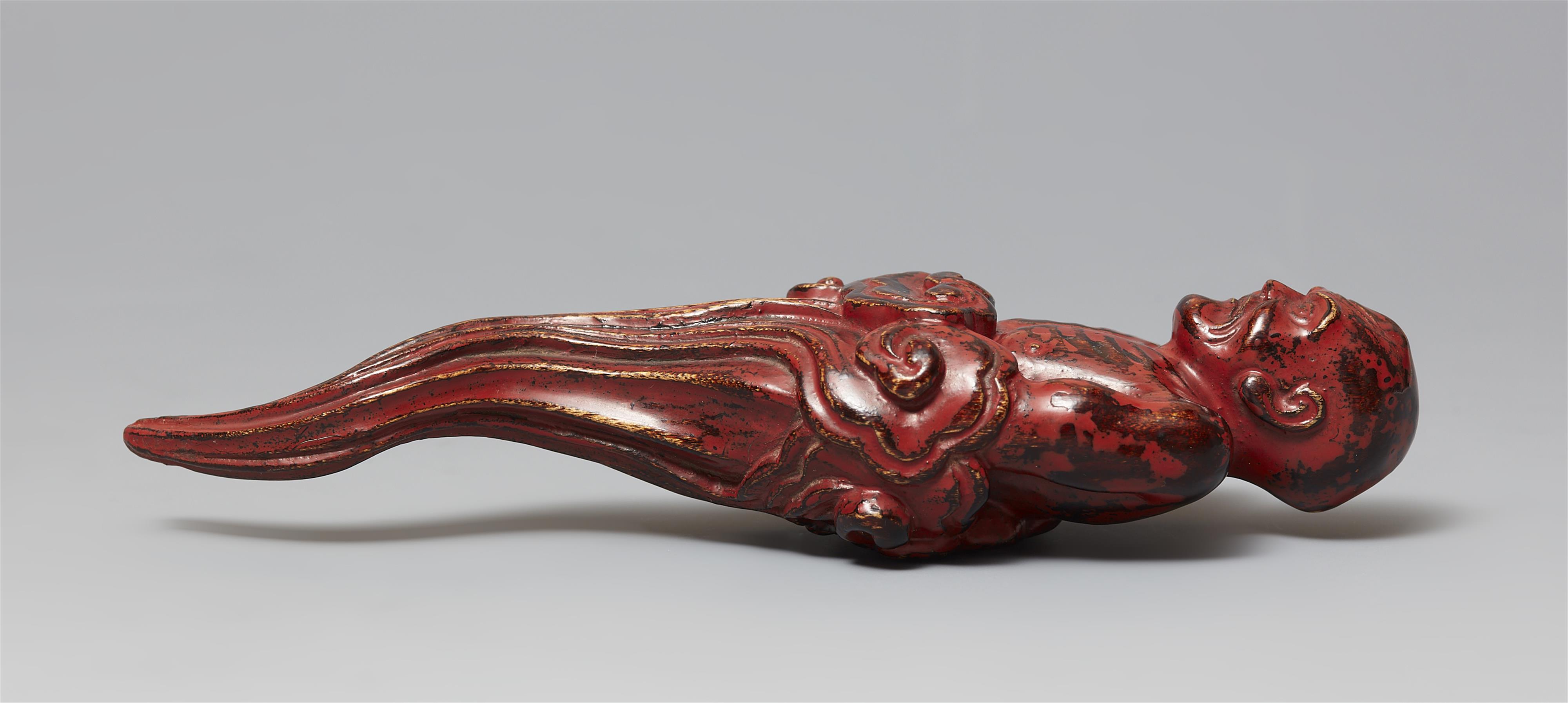 A black and red-lacquered softwood netsuke of a man rising from a cloud. 19th century - image-6