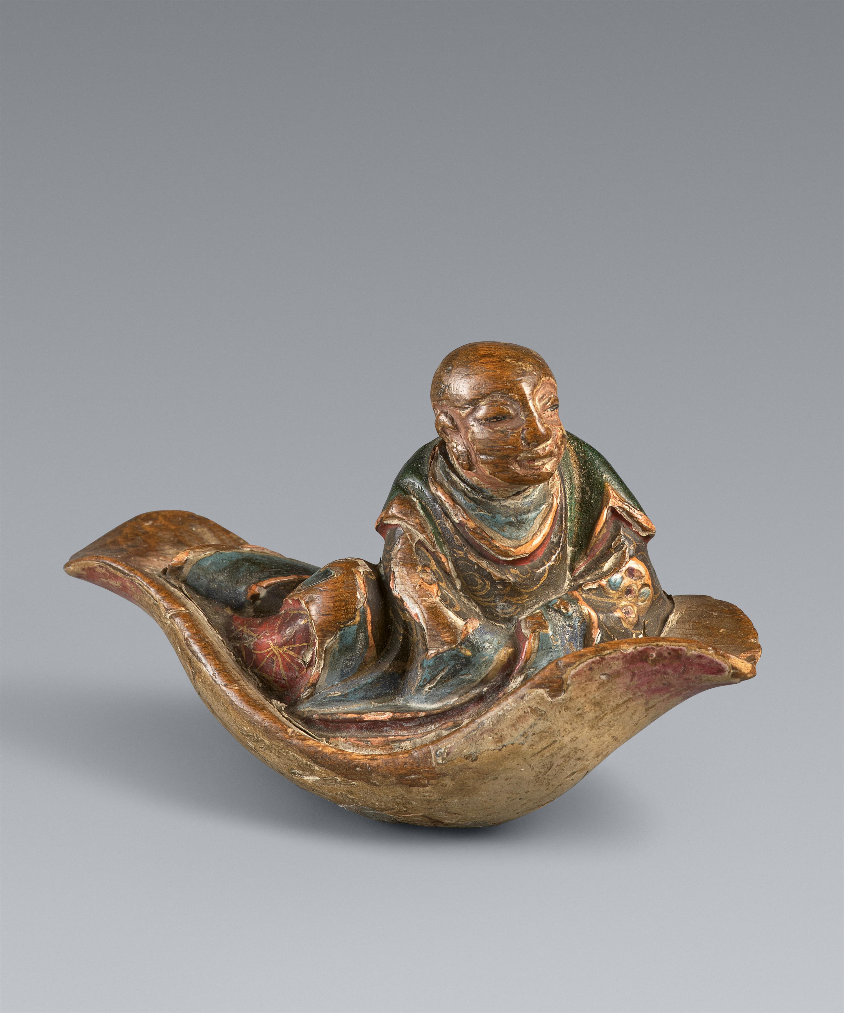 A painted softwood netsuke of a monk on a leaf. 18/19th century - image-1