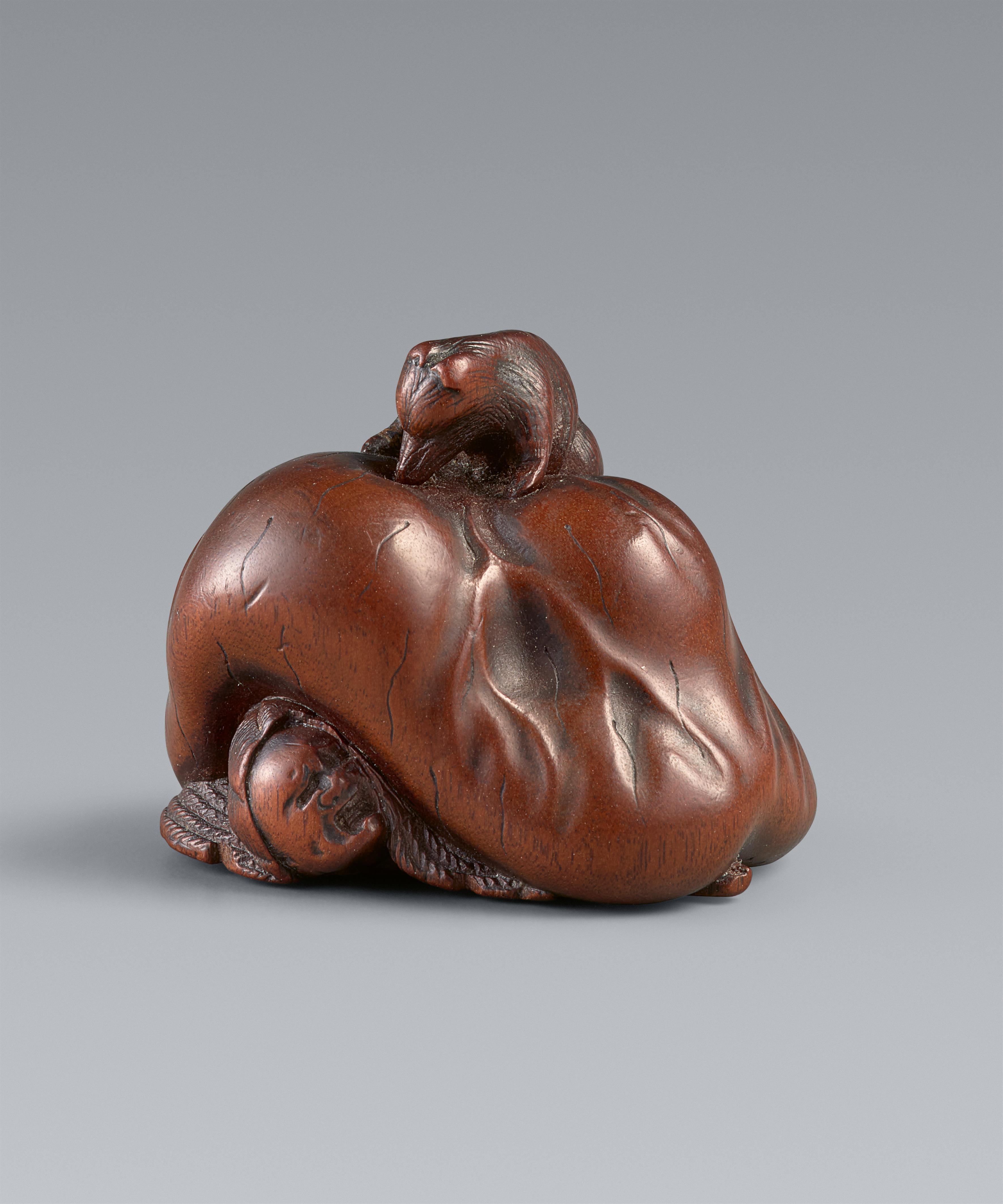 A Ise-Yamada wood netsuke of a tanuki smothering a hunter by Masakazu. Second half 19th century - image-1