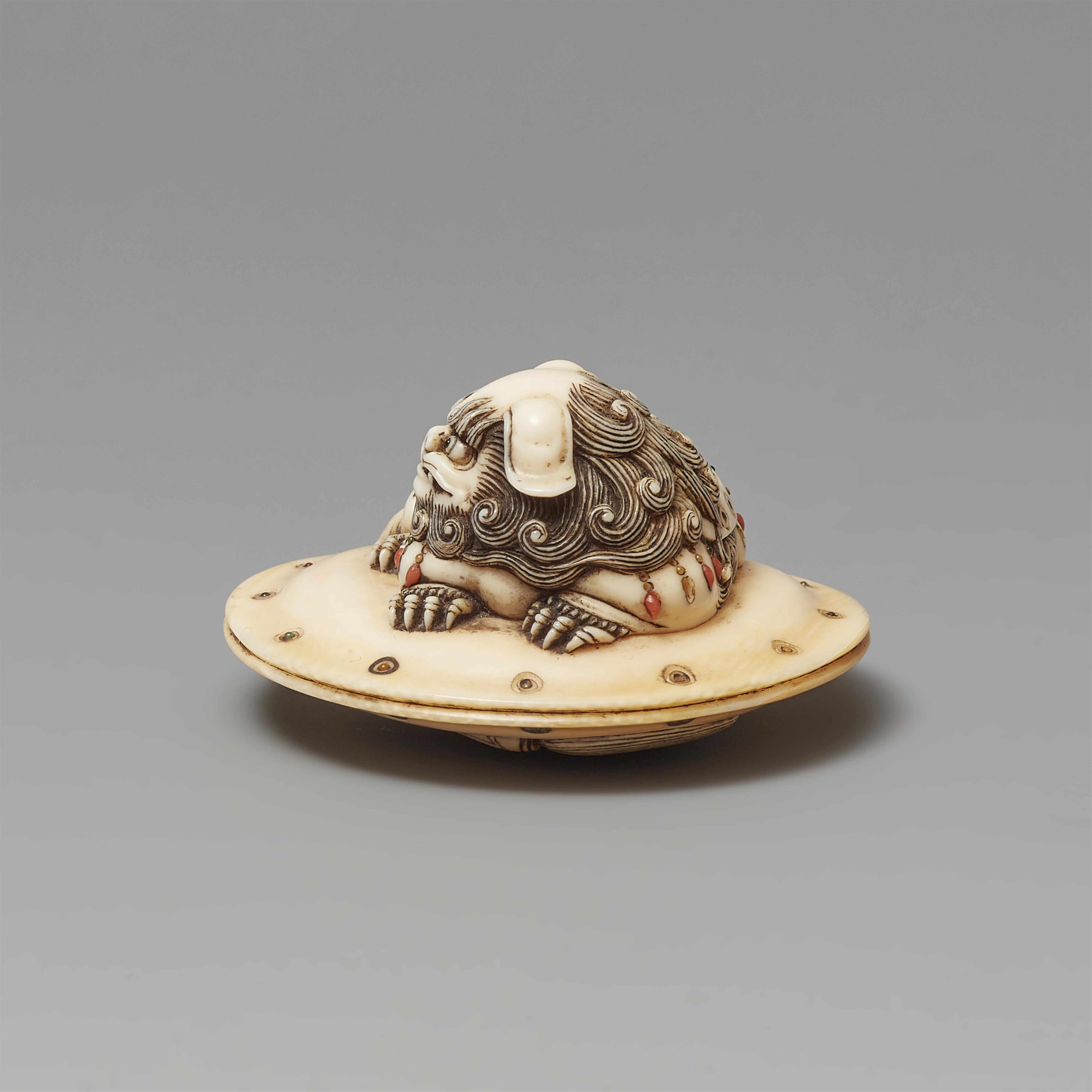 An ivory netsuke of a caparisoned shishi on a cushion. Mid-19th century - image-2