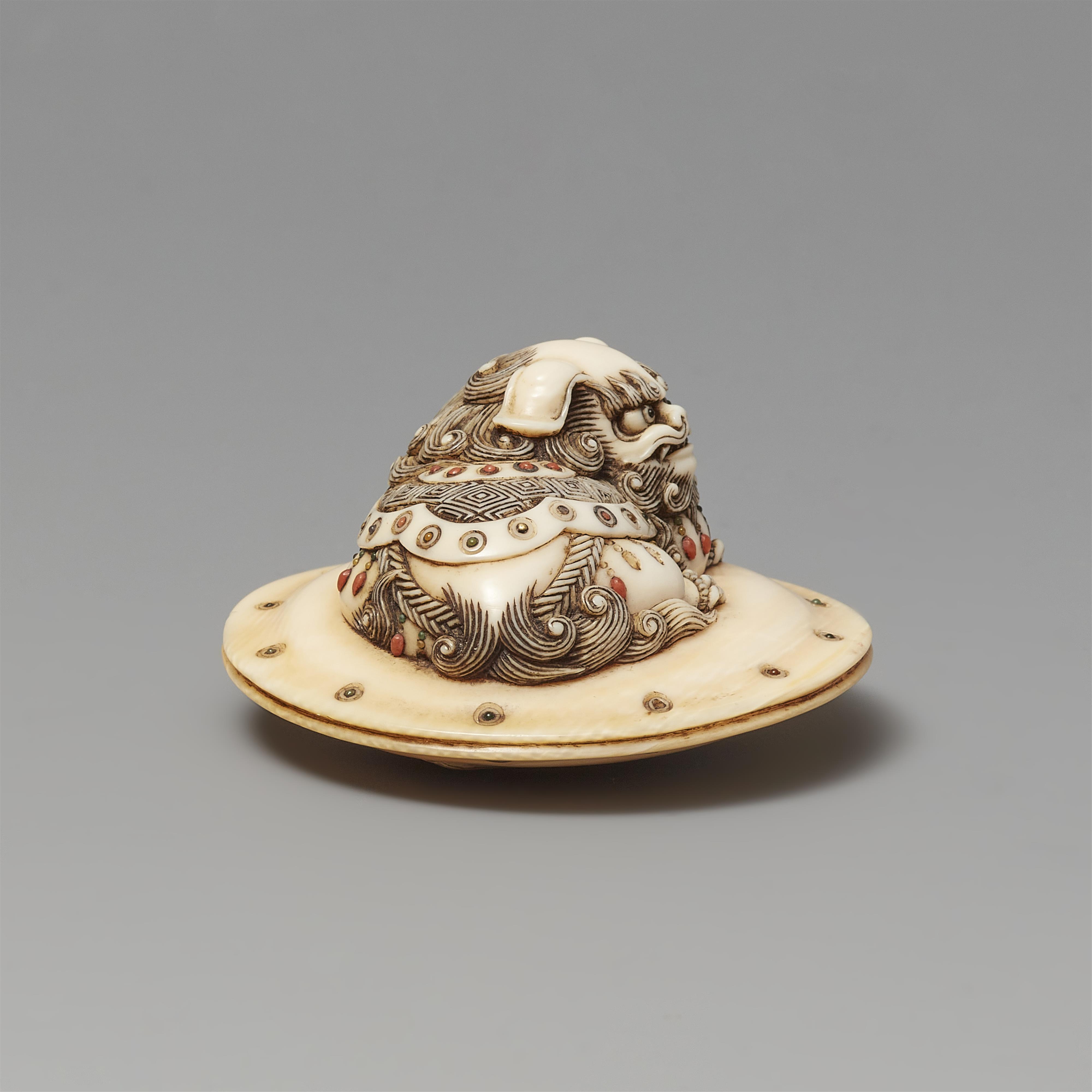 An ivory netsuke of a caparisoned shishi on a cushion. Mid-19th century - image-4