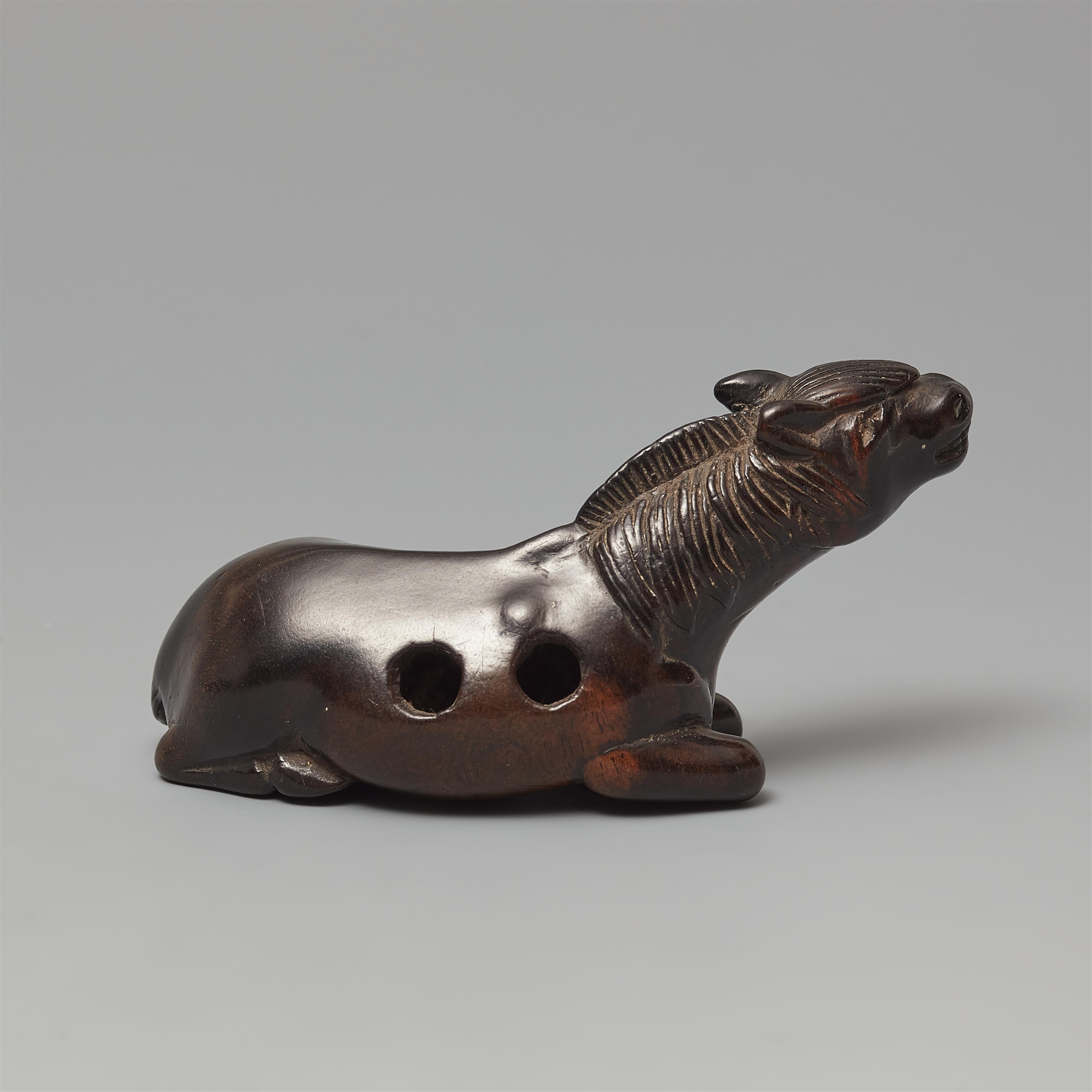 A large probably kaki wood netsuke of a recumbent stallion. 19th century - image-2