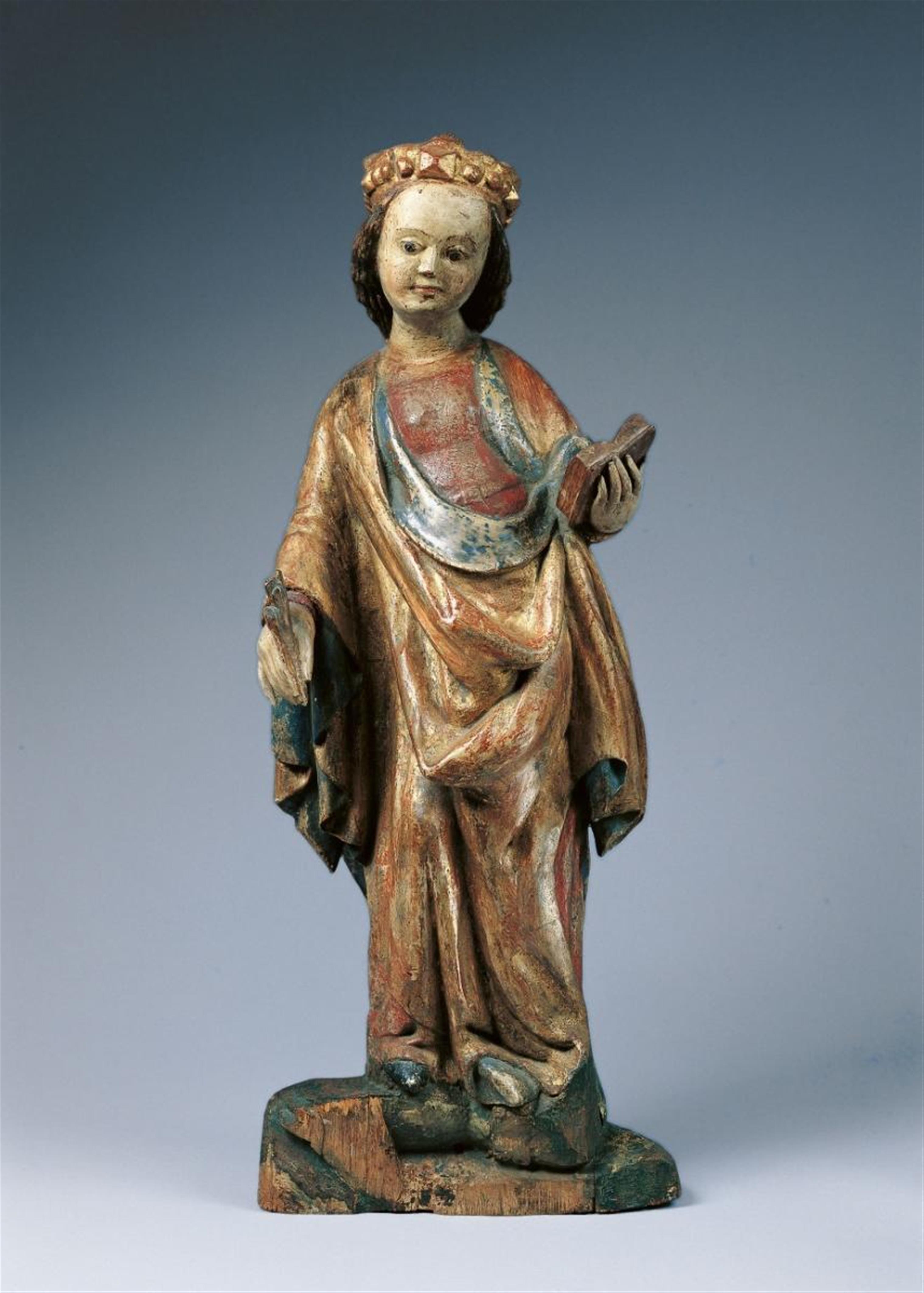 A high relief wood figure of A SAINT HOLDING A BOOK AND A PALM LEAF - image-2