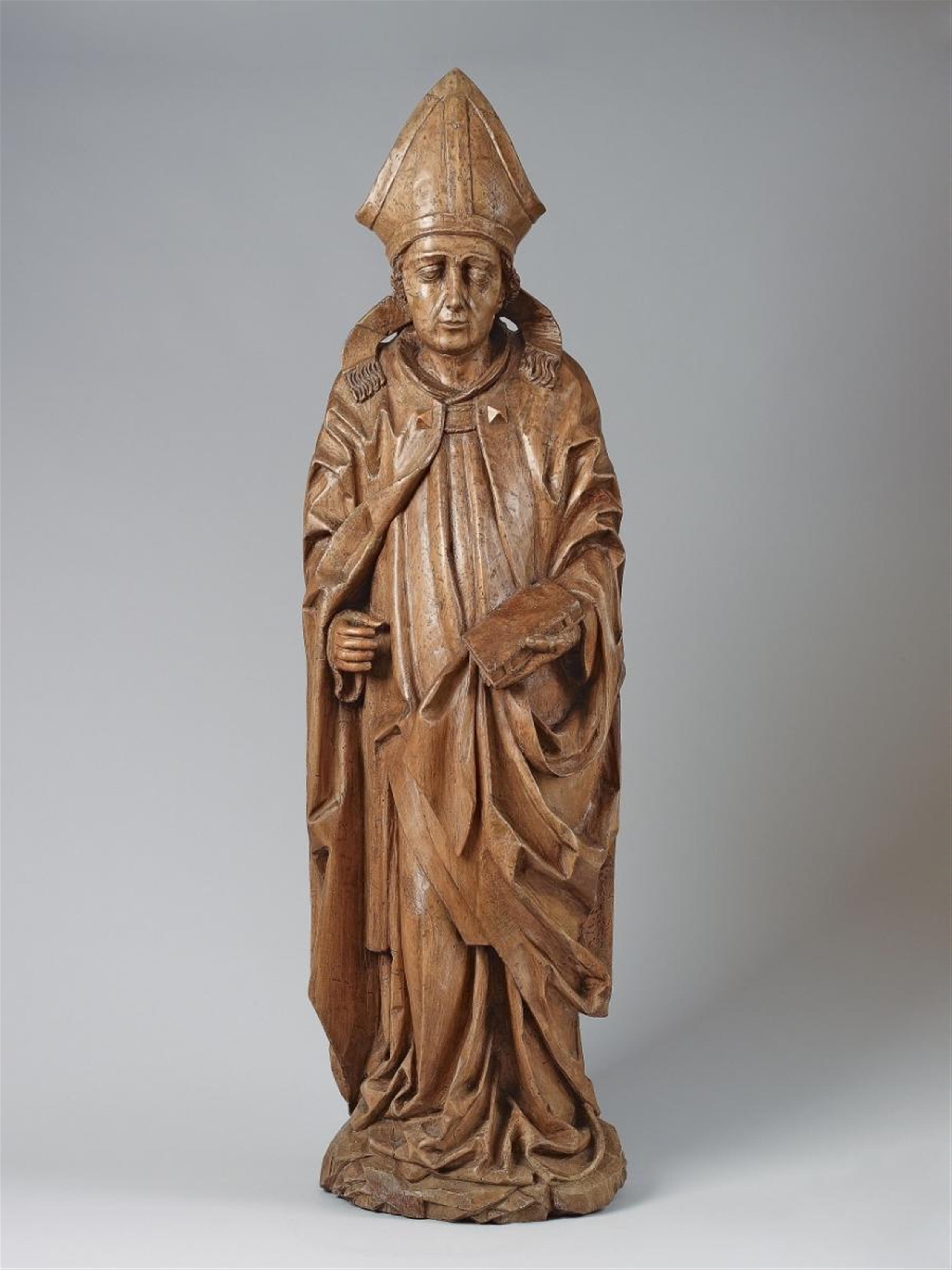 A high relief wood figure of A BISHOP-SAINT - image-1