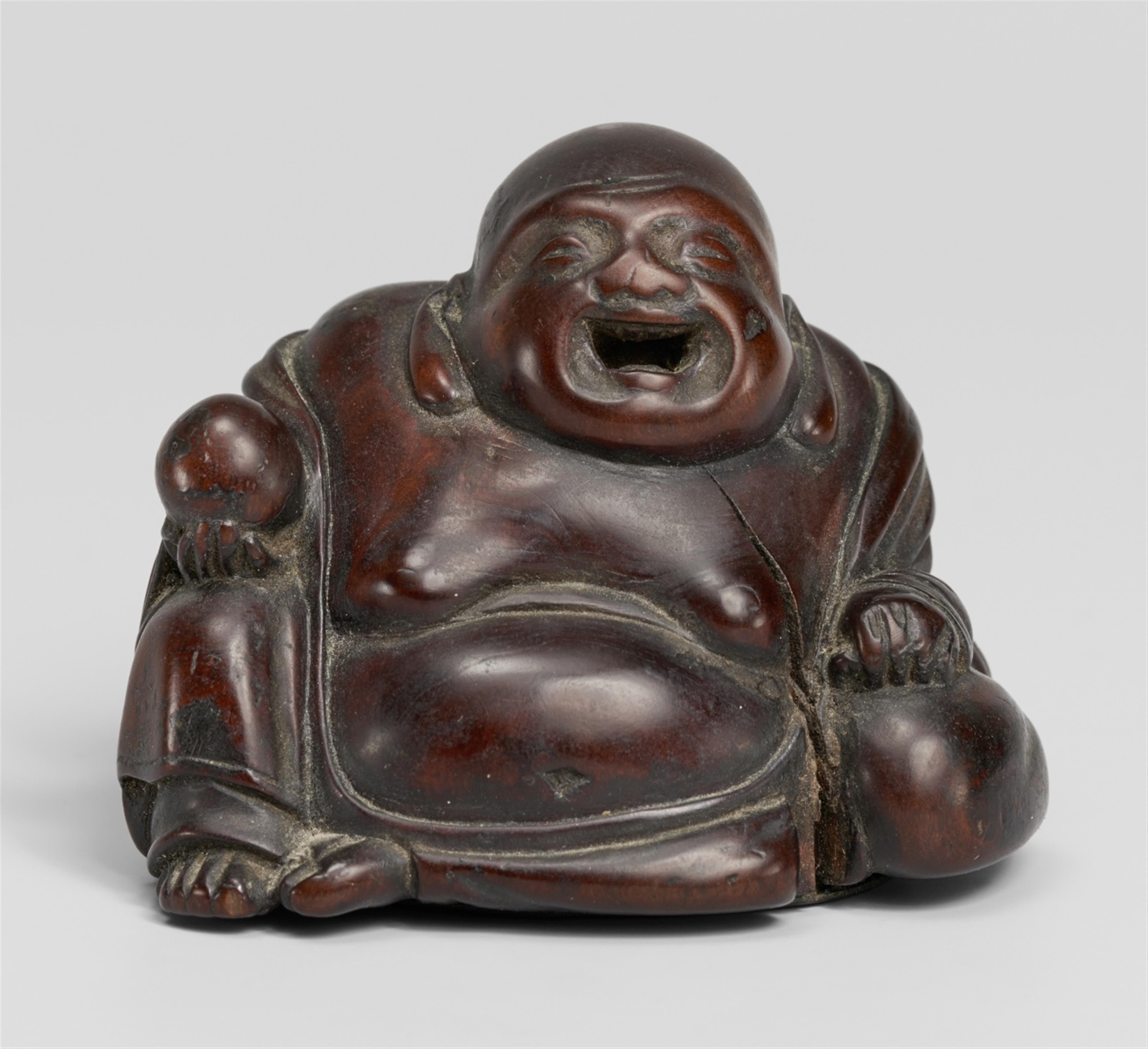 A wooden ashtray netsuke of Hotei. 19th century - Lot 796