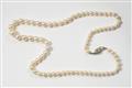 An Art Déco platinum, yellow gold and pearl necklace. - image-1