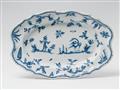 An oval Alcora faience dish with blue "grotteschi" decor - image-1